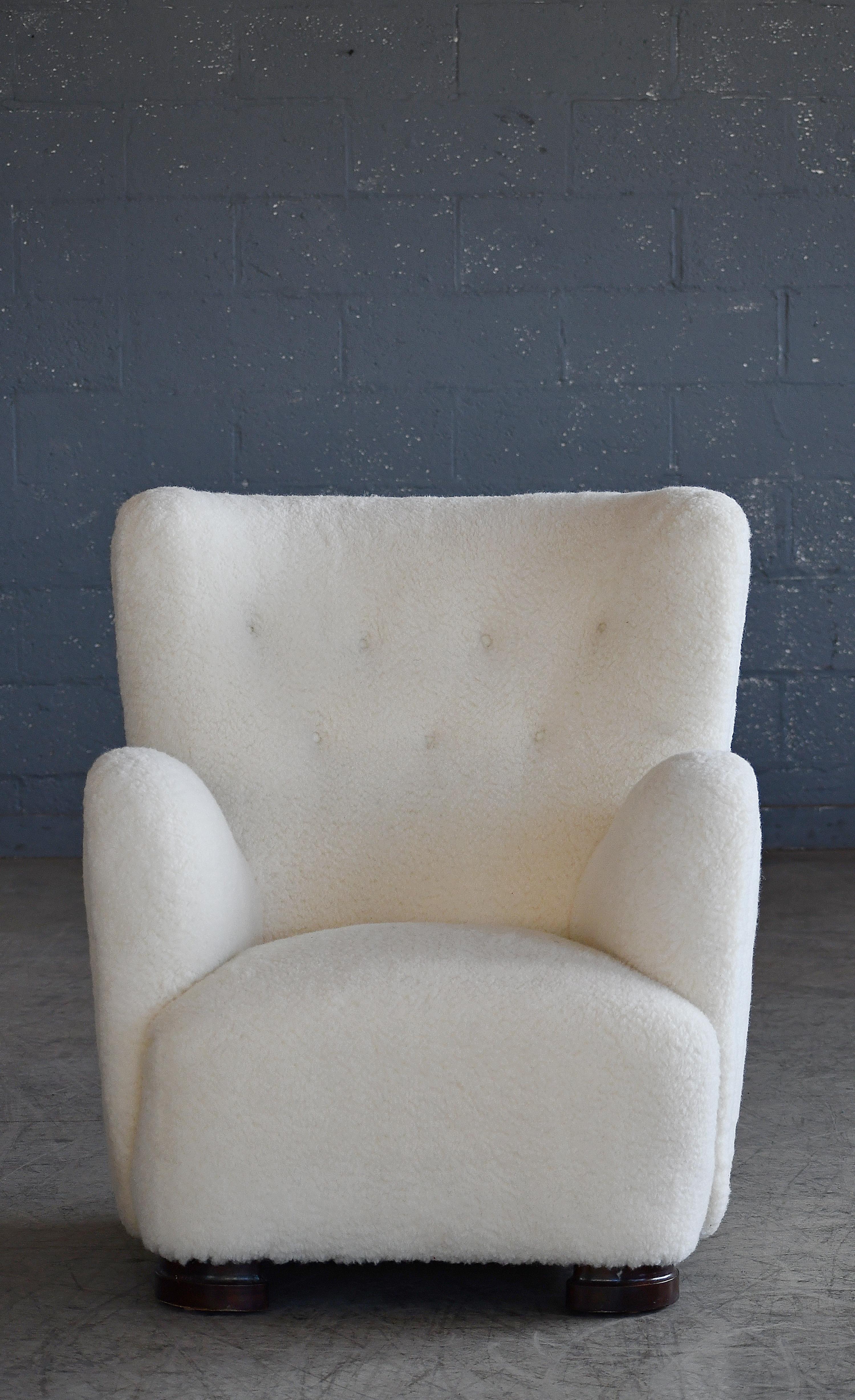 Fritz Hansen attributed 1940s Danish highback lounge chair in Lambswool. Sublime highback lounge chair with channeled backrest made in Denmark in the late 1930s or early 1940s. This model chair is seen from time to time in the Danish market and is
