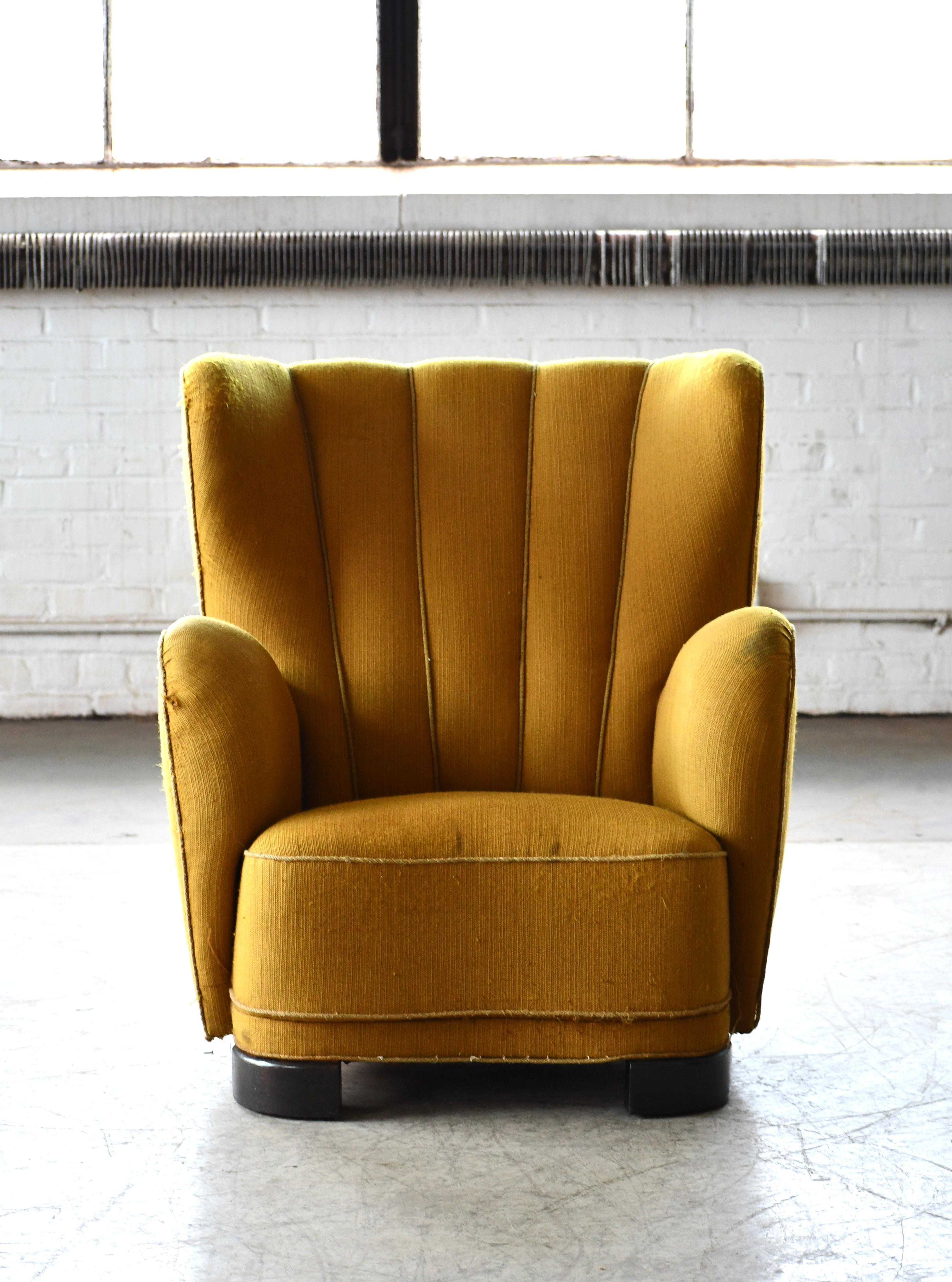 Fritz Hansen attributed 1940s Danish highback lounge chair in wool. Sublime highback lounge chair with channeled backrest made in Denmark in the late 1930s or early 1940s. This model chair is seen from time to time in the Danish market and is often