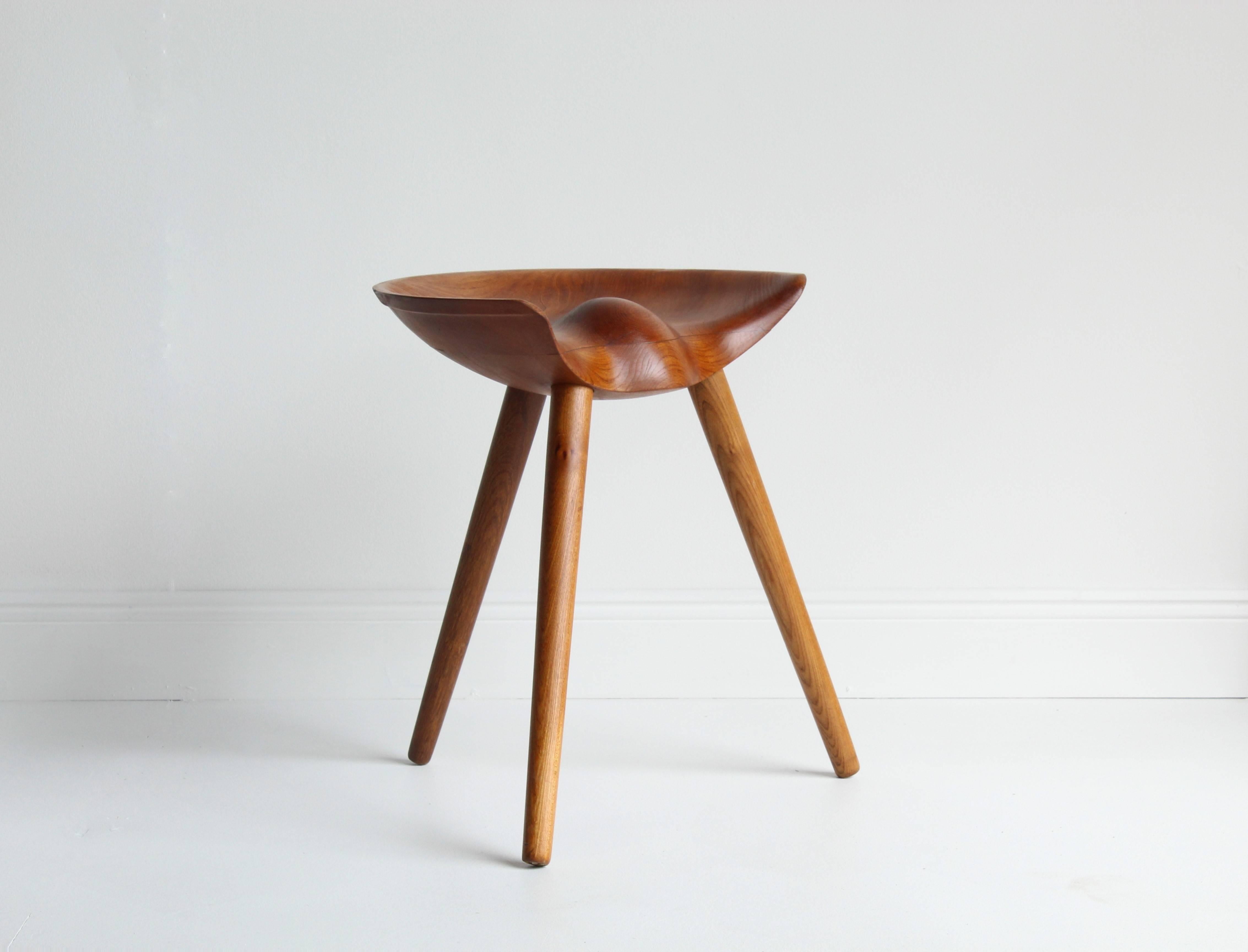 A modernist stool designed by architect Mogens Lassen, made by cabinetmaker K. Thomsen. The seat is sculpted from elm with oak turned legs. This model was presented at The Copenhagen Cabinetmakers' Guild Exhibition at Designmuseum, Denmark, 1942.