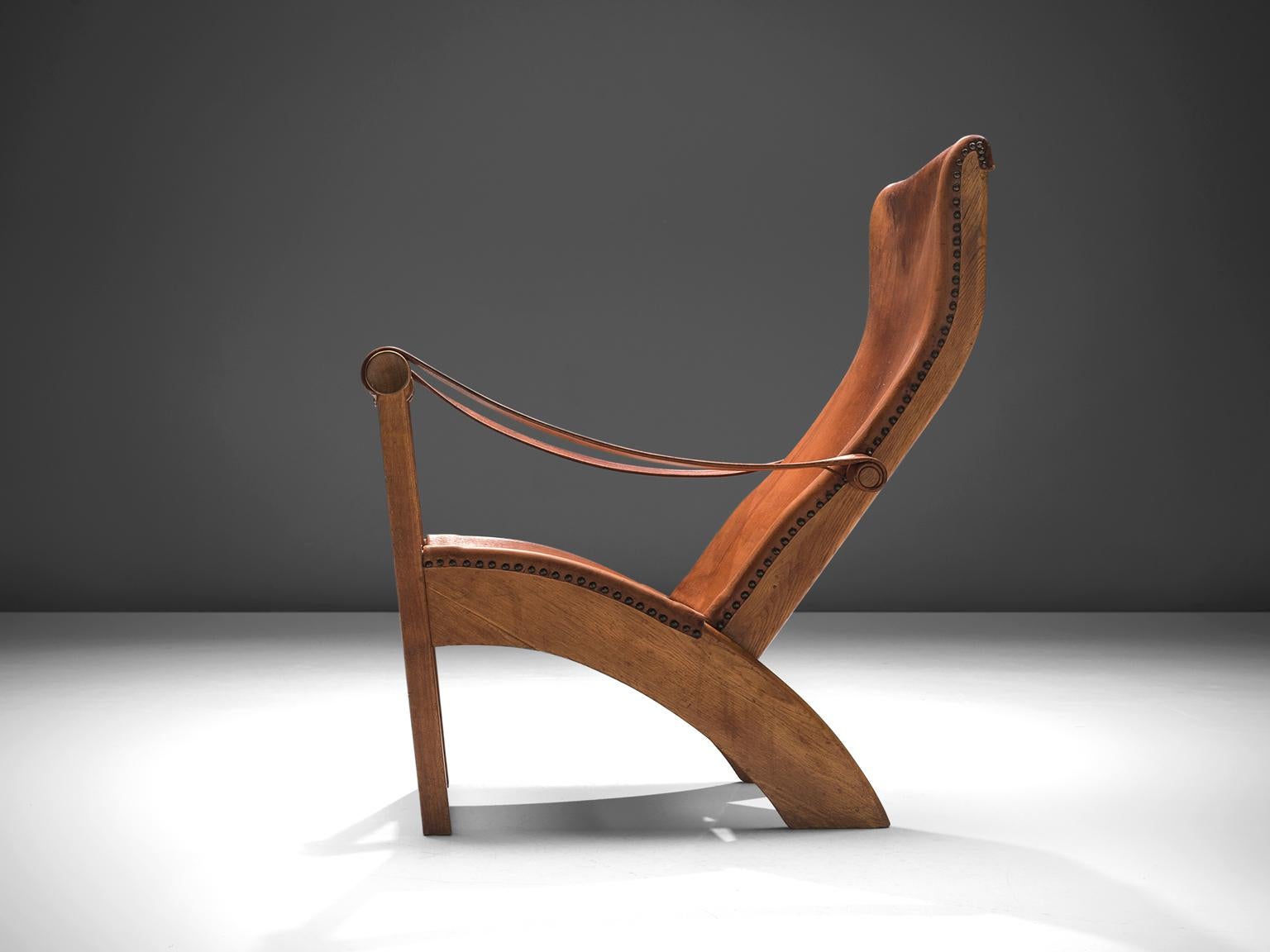 Mogens Voltelen for cabinetmaker Niels Vodder, lounge chair model 'Københavnerstolen', beech and cognac leather, Denmark, 1936. 

This Copenhagen lounge chair is designed by Mogens Voltelen. Classic early edition in which the armrests are attached