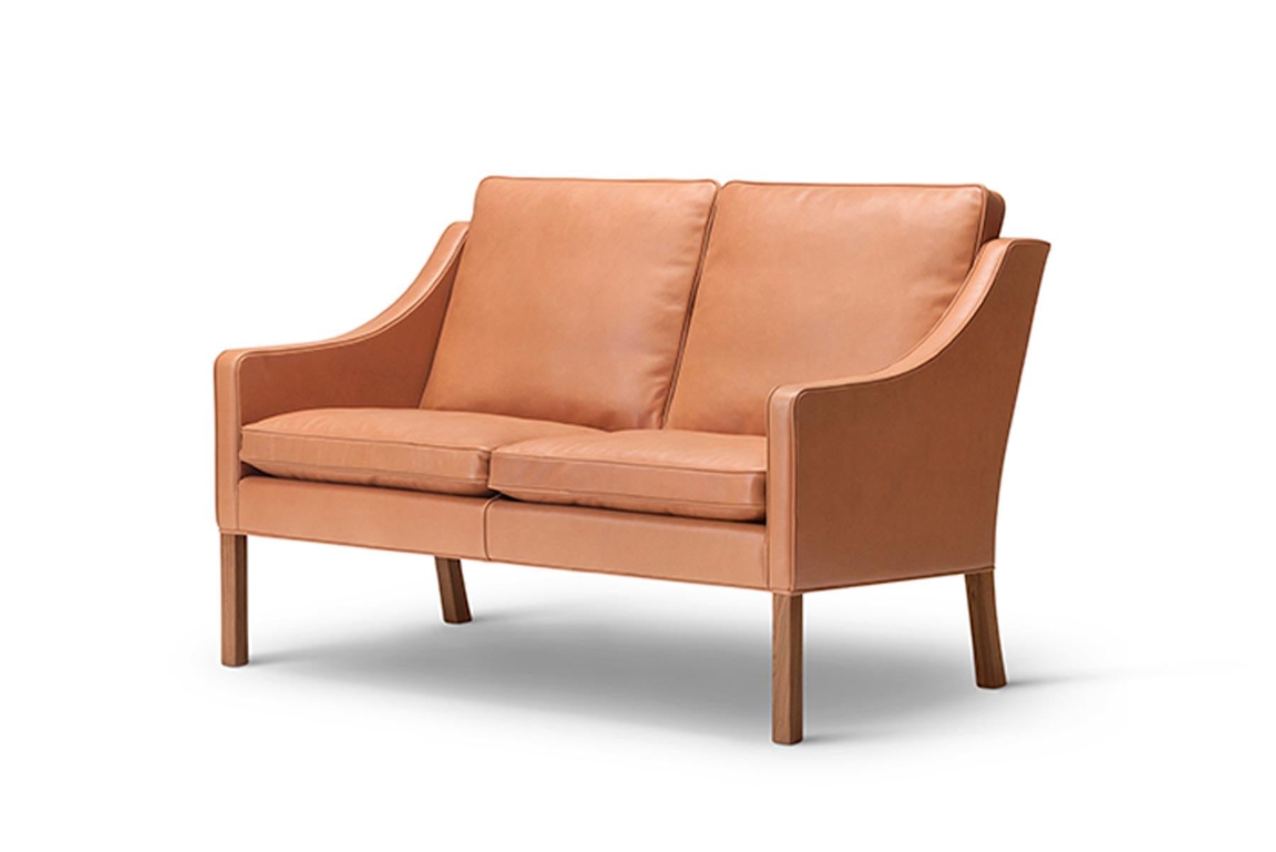 The 2208 two seater sofa features an elegantly curved lowered back and was designed by Børge Mogensen in 1963.