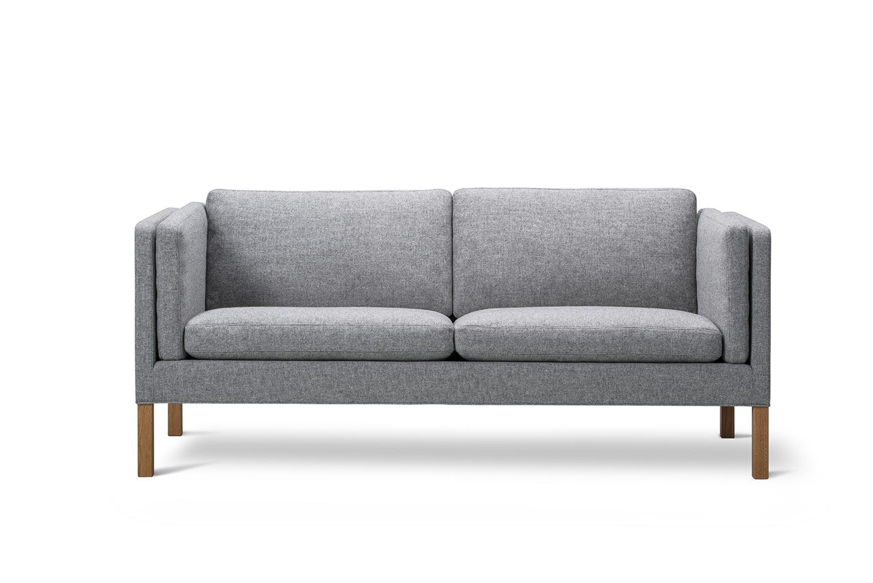 The 2335 sofa was designed by Børge Mogensen’s son, architect Peter Mogensen, as a completion of his father’s last furniture series. The extended width of the cushions softens the formality of the design in a respectfully unpredictable way.