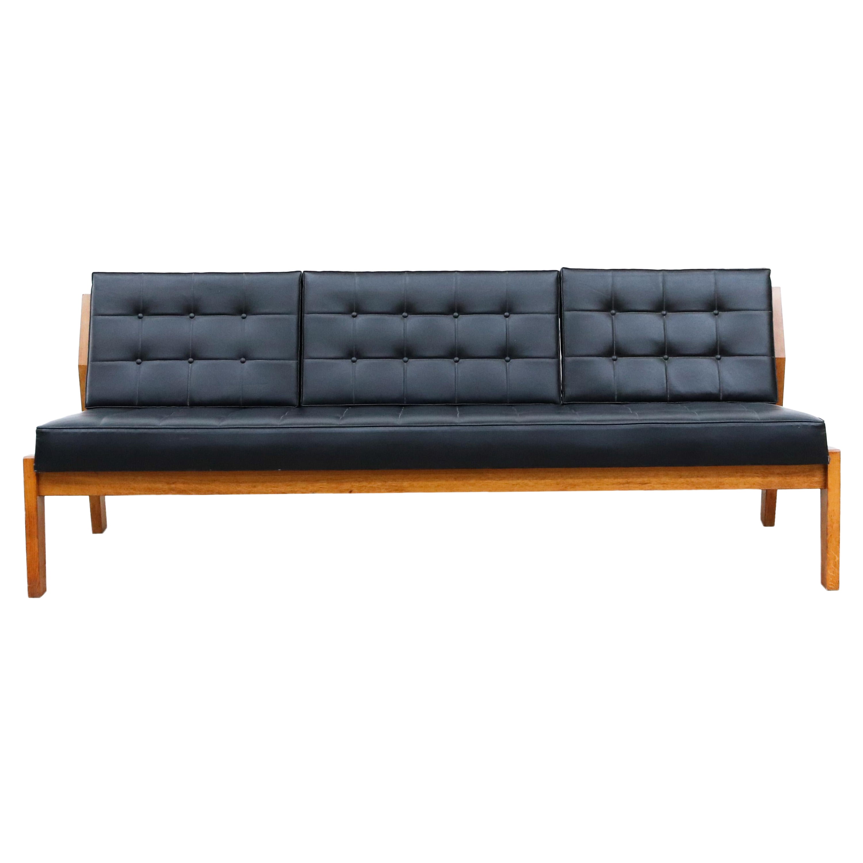 Large Dutch armless oak slat bench with original black skai cushion. Can be used with or without back cushions. Beautifully built, heavy and handsome piece. In original condition with wear consistent with it's age and use. Other similar benches