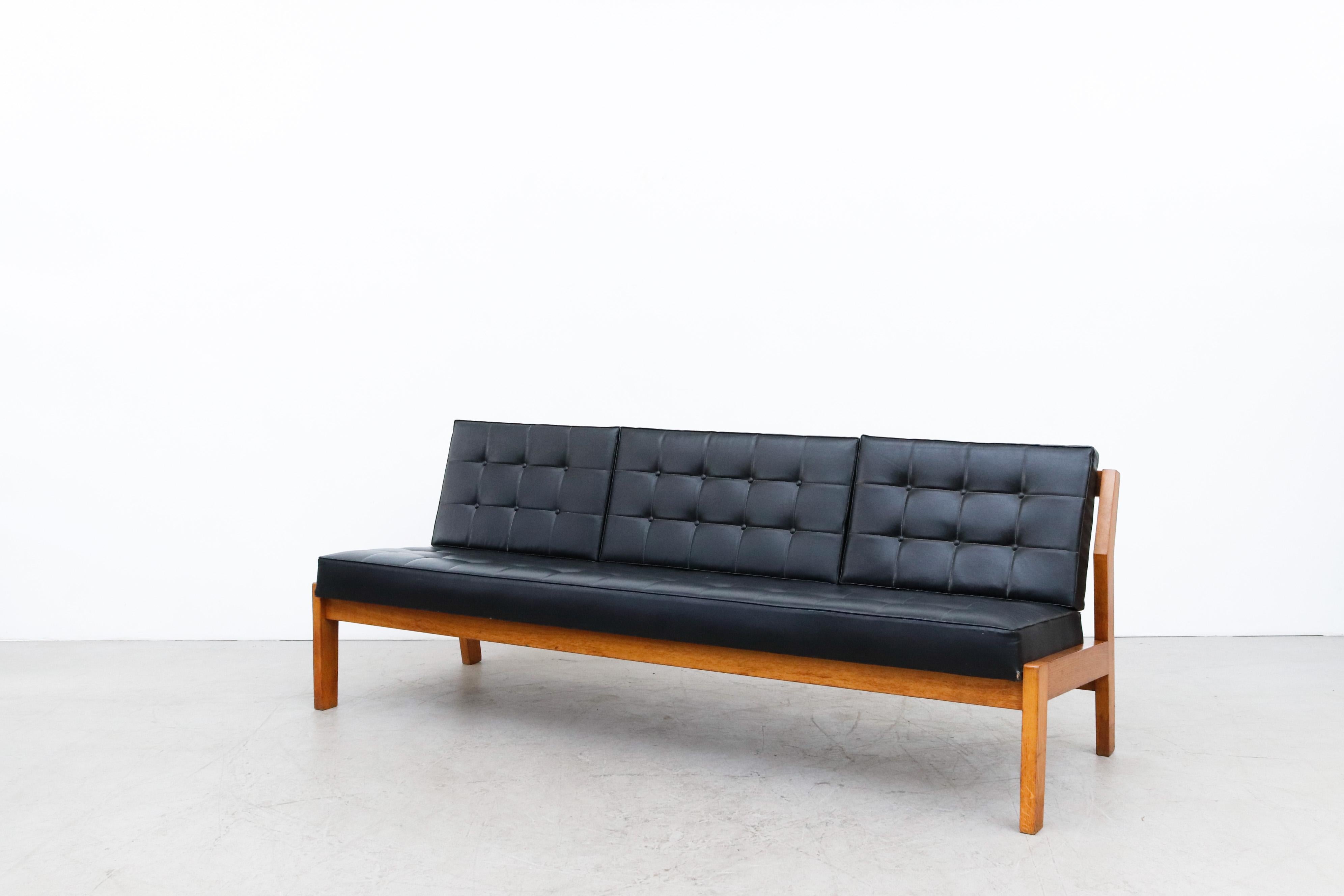 Large armless oak slat bench with original black skai cushion, reminiscent of the J103 Sofa by Børge Mogensen. Can be used with or without back cushions. Beautifully built. Heavy and handsome piece. In original condition with wear consistent with