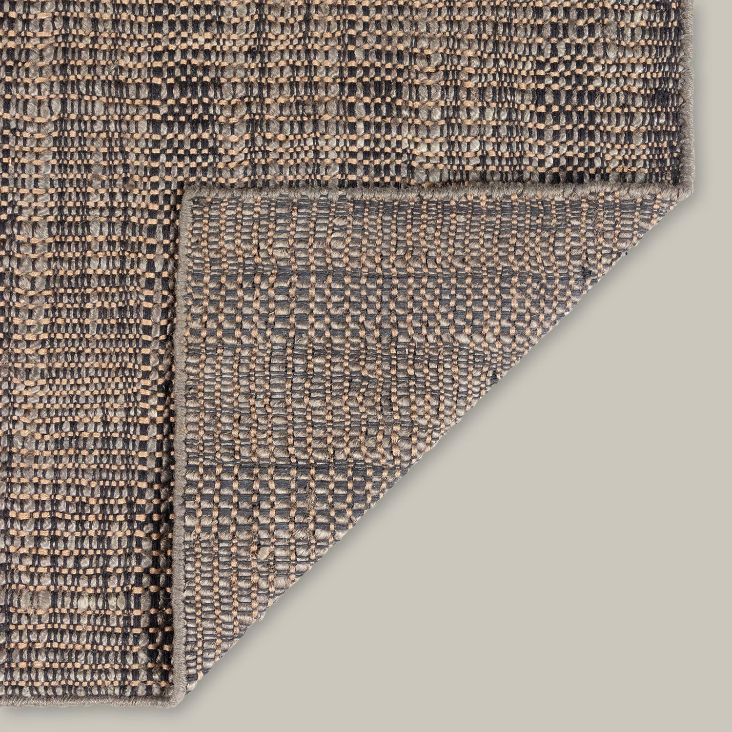 The quality of the line pattern sets the Moghar Collection apart. A handwoven jute flatweave, the subtle gradations of color work together to create an elevated basic. Built for layering, the wonky lines and irregular texture all have a very