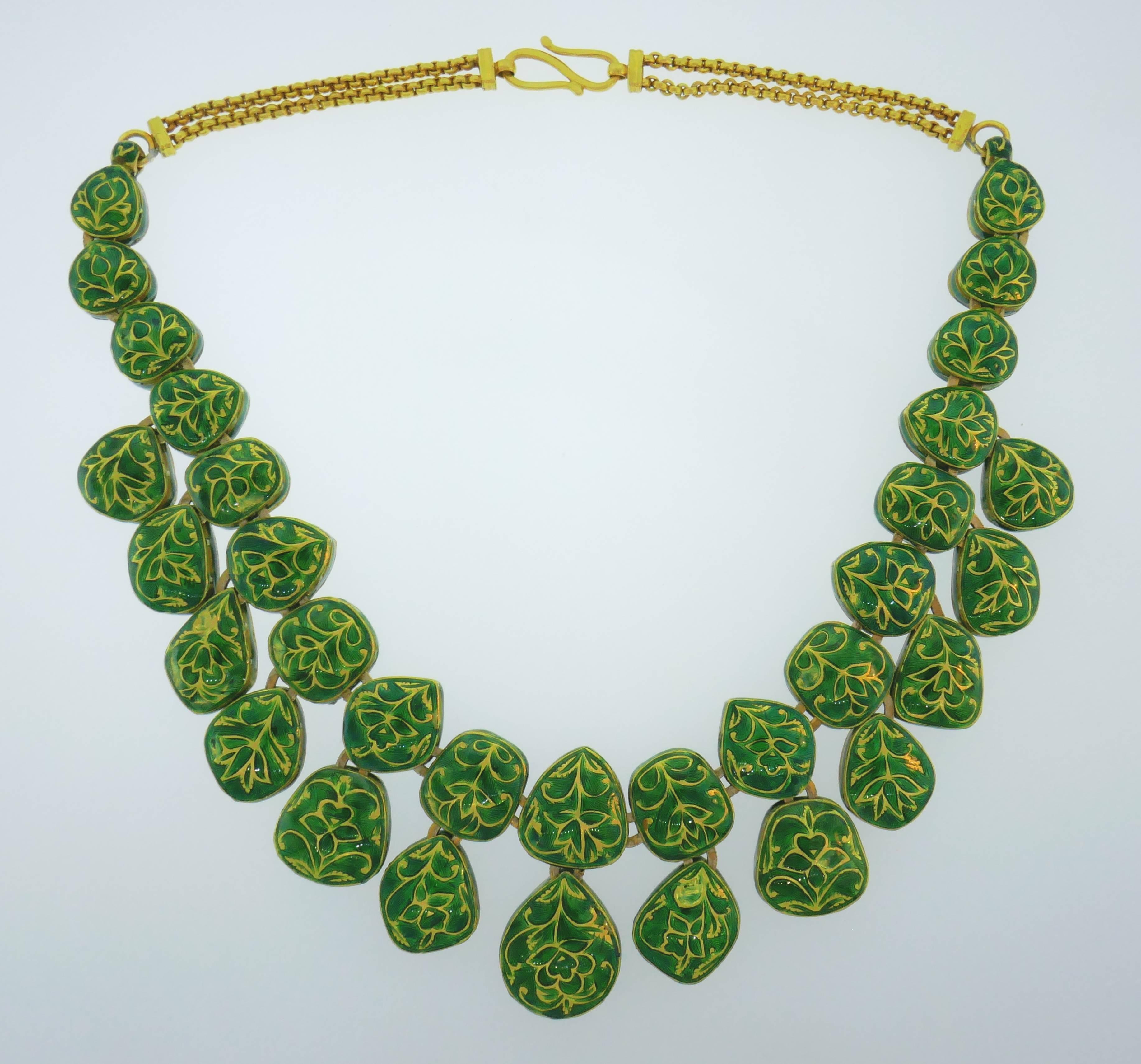 Bold and striking double-sided necklace.  Making a statement yet wearable, the necklace is a great addition to your jewelry collection. 
The necklace is made of 18 karat yellow gold, green enamel and rose cut diamonds.
It is 17 inches x 1-1/2 inches