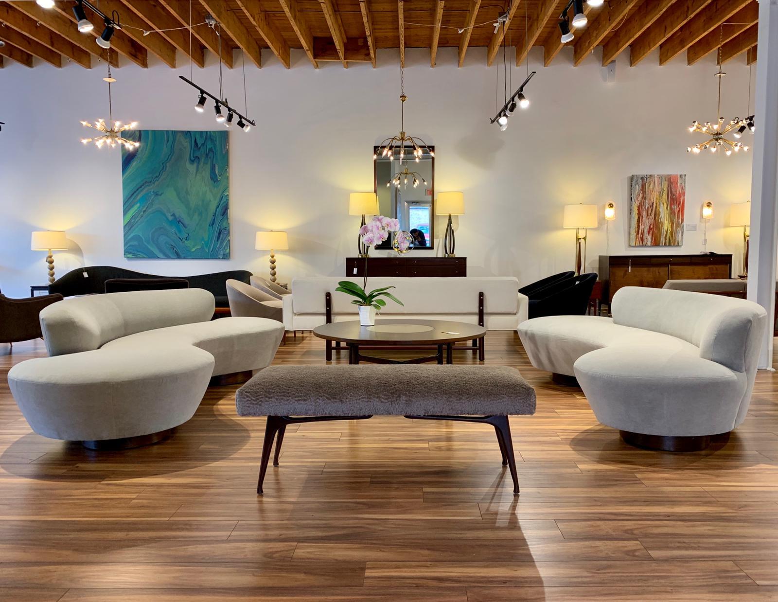 Serpentine sofa designed by the late Vladimir Kagan for Directional, circa 1970s. This rare example features fully restored walnut bases as well as Lucite support.

Newly upholstered in grey mohair.
  
