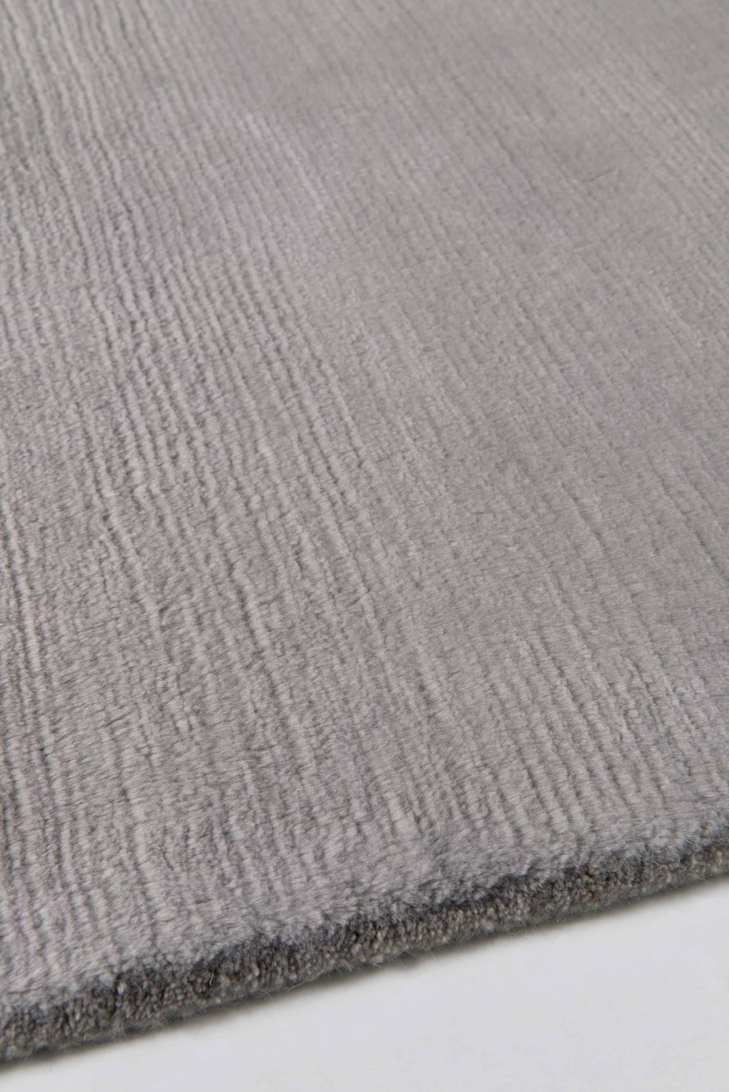Crafted from soft mohair wool, this simple, modern rug is hand-knotted into a plain, textural finish with a luxurious sheen. Mohair Dove is an elegant addition to your home and is available in any size and color, and a deep or short