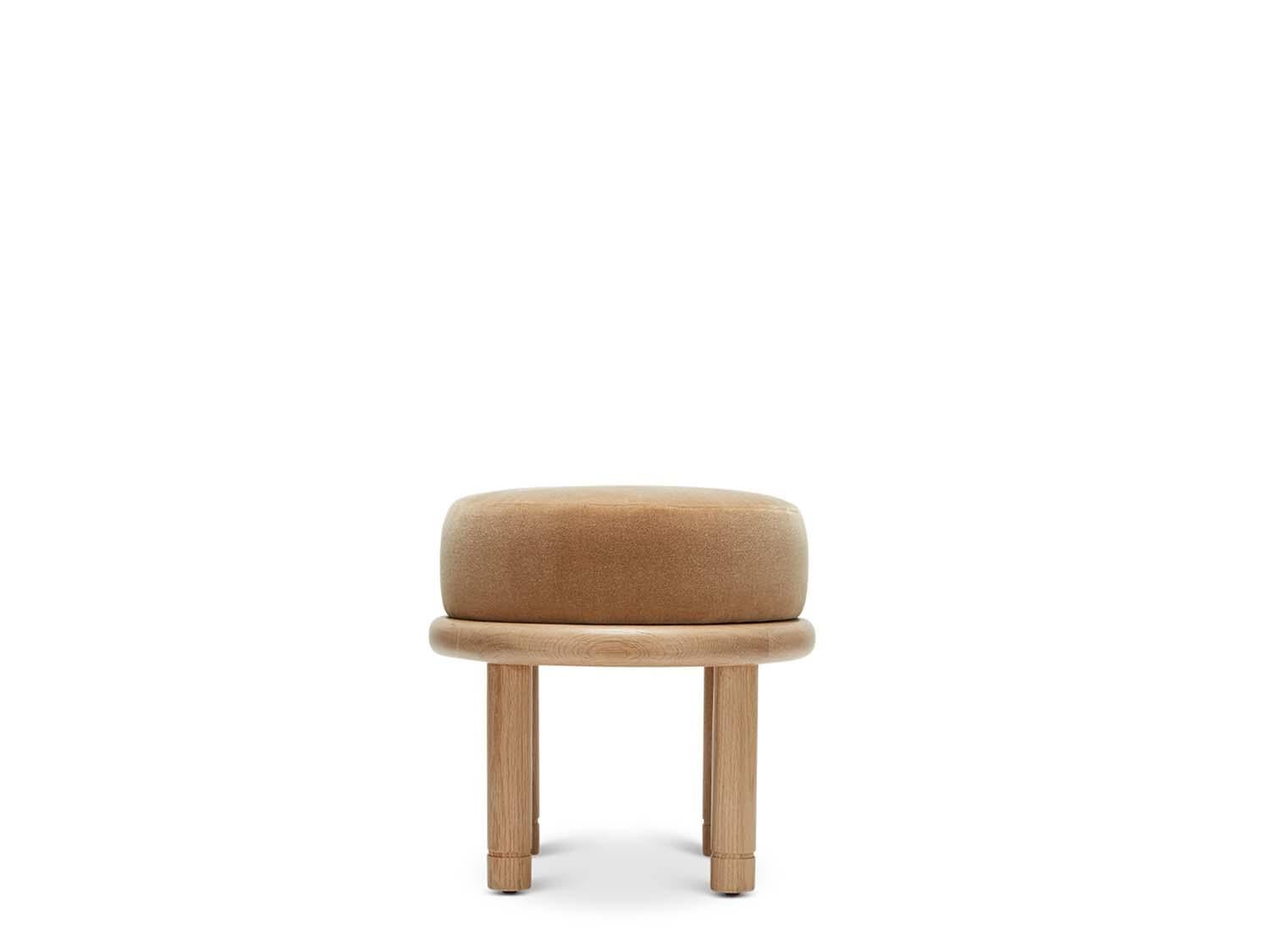 The Petite Moreno ottoman features a round solid wood base with four cylindrical legs and an upholstered top. Available in American walnut or white oak. 

 The Lawson-Fenning Collection is designed and handmade in Los Angeles, California. Reach