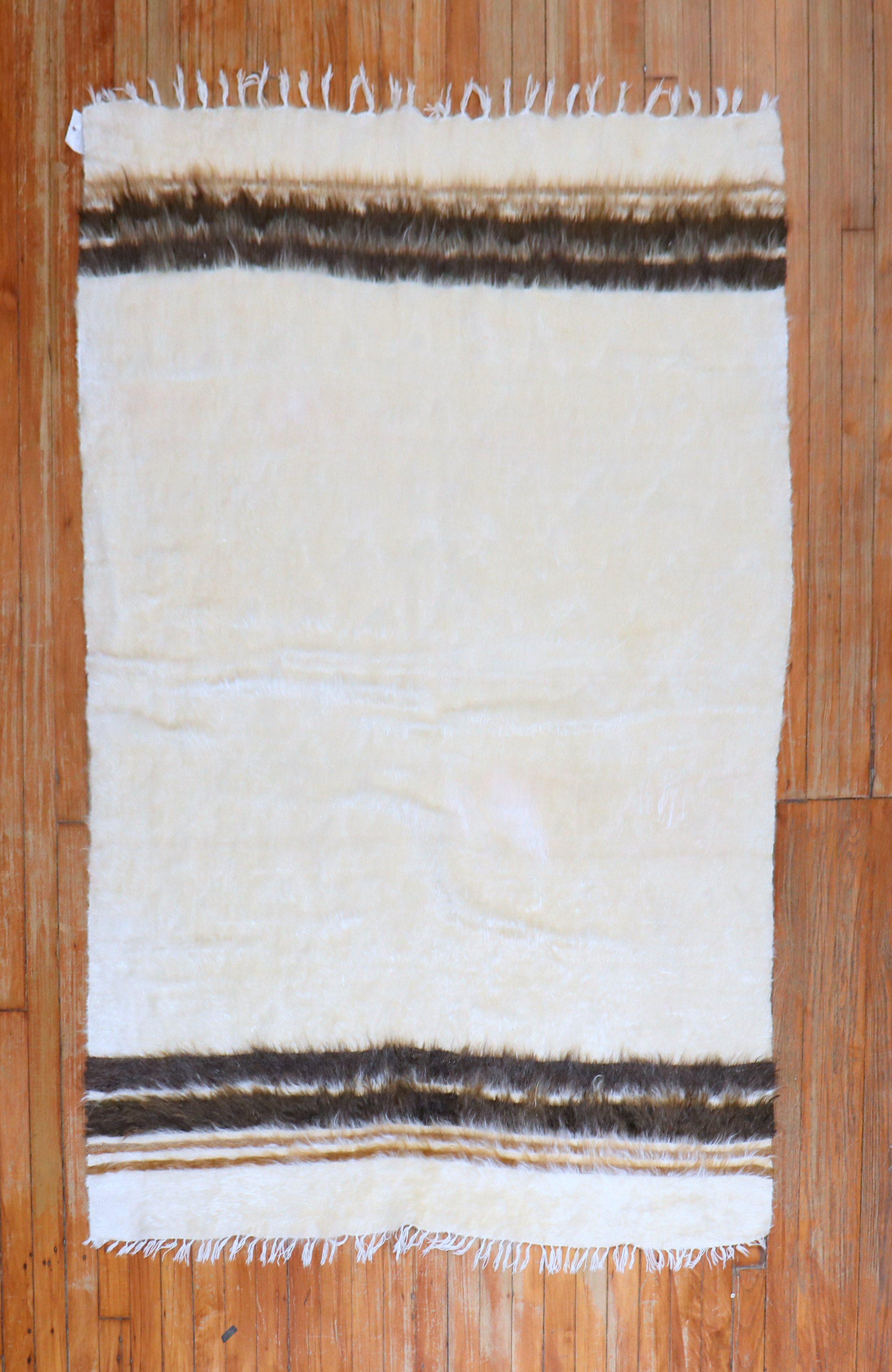 A mid 20th Century Turkish Mohair rug in ivory, brown and black

Measures: 4' x 5'10''.