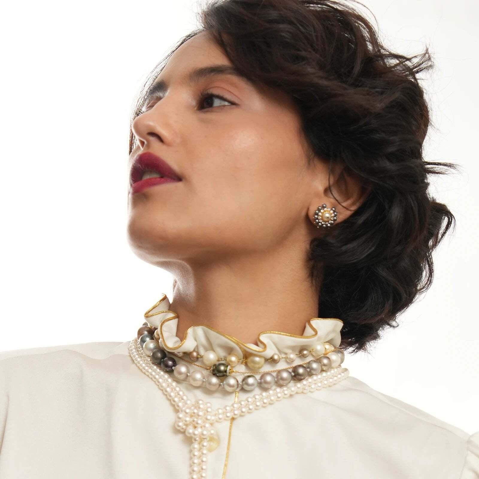 Gold(14K) : 6.70g
Brilliant cut Diamonds : (VS clarity & H-I colour) : 0.55ct
Cultured Pearls : 2.23ct 
Terahertz : 9.22ct
Emerald : 0.08ct

Audrey pearl ear studs is handcrafted in gold and holds a diamond-pierced pearl dearly at its heart, lined