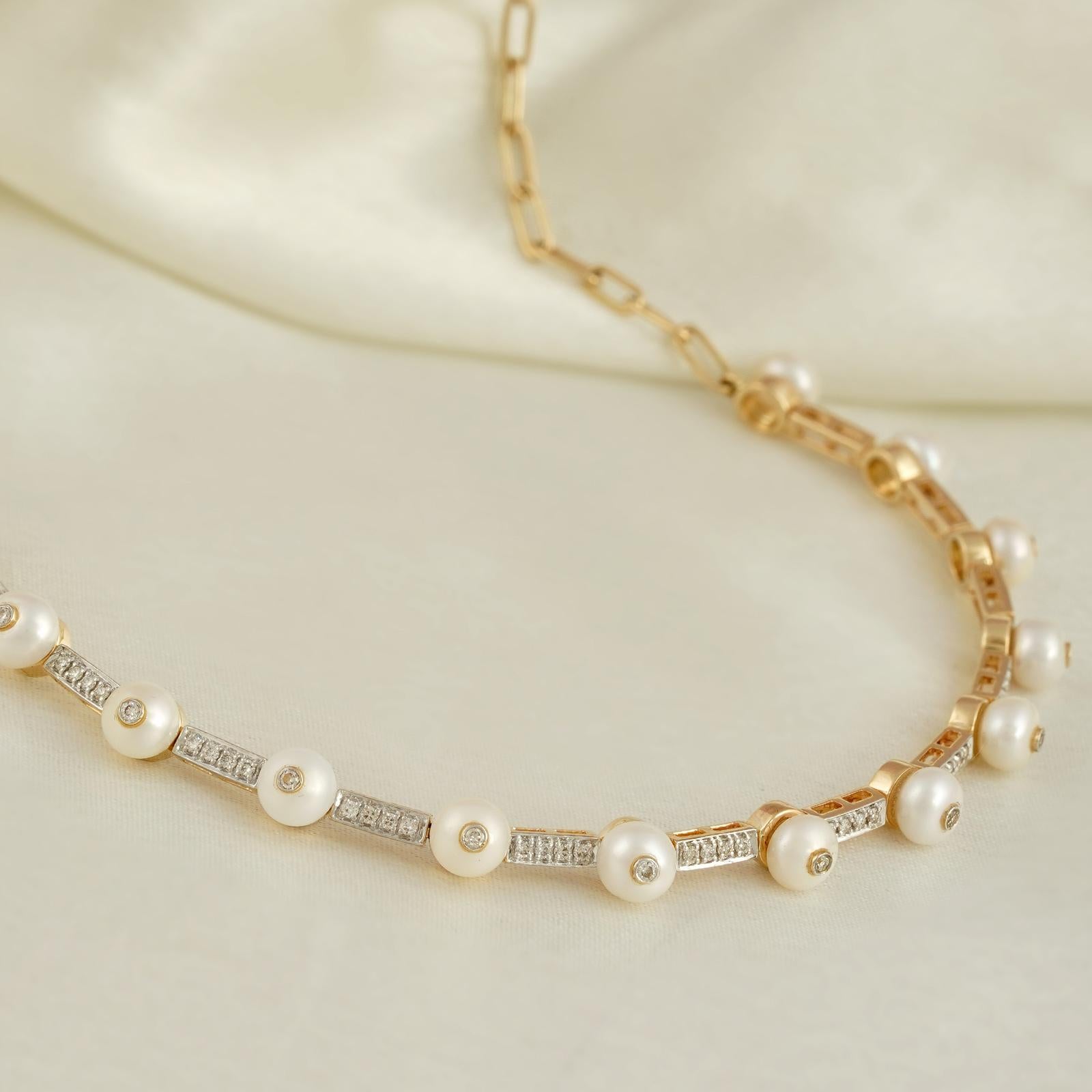 Gold(14K) : 17.08g 
Diamonds : (VS clarity & H-I colour) : (Brilliant cut ) : 0.79ct Gemstone : Chinese Cultured Pearl

You cannot go wrong with pearls and diamonds, can you? This necklace here is crafted in gold to sit cozily on the nape of your