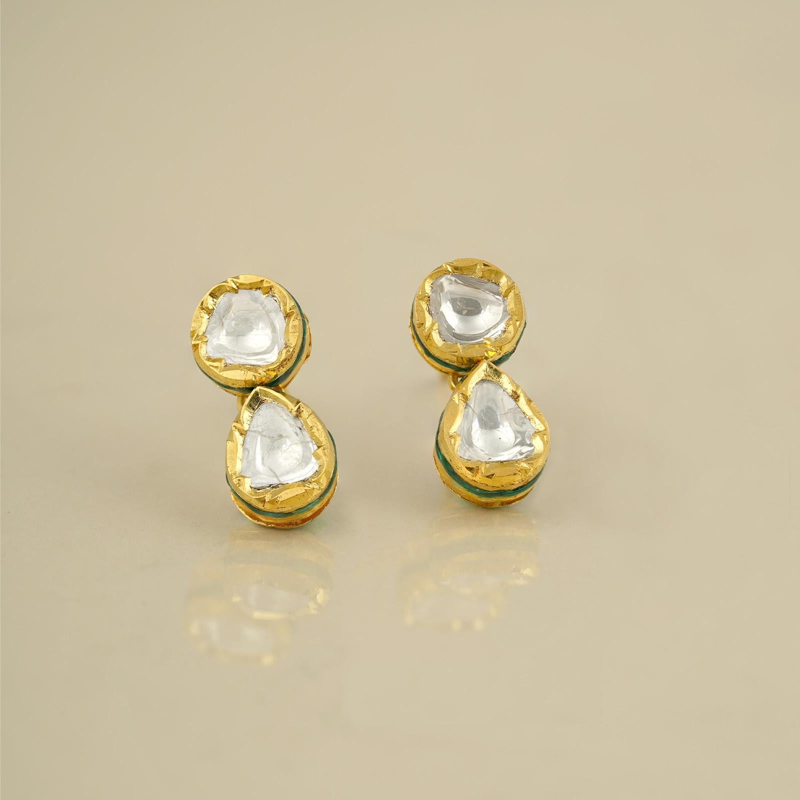 Gold(22K) : 1.16g
Gold(18K) : 5.70g
Uncut Diamonds/Vilandi/Polki : 1.30ct
Other : Green Enamel, Red Enamel and White Enamel

An extremely versatile pair, the Dia earrings feature 22k gold and polki (uncut diamond). With its gold and white old-world