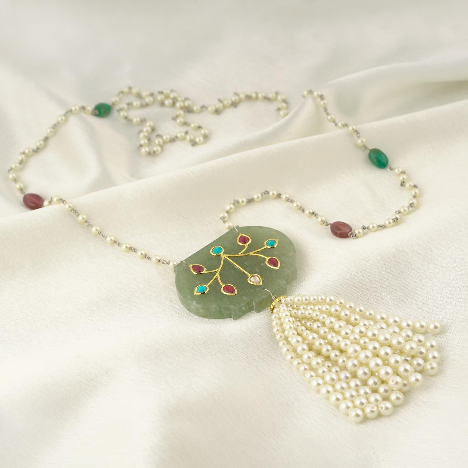 Gold(22K) : 1.53g
Gemstones : Ruby, Turquoise, Adventurine, Shell Pearls, Emerald
The chain is worked in a 925 silver.

Inspired from the ornate 'Haldili' or amulets prevalent with the Mughals, this is our minimal take on the style. The Adventurine