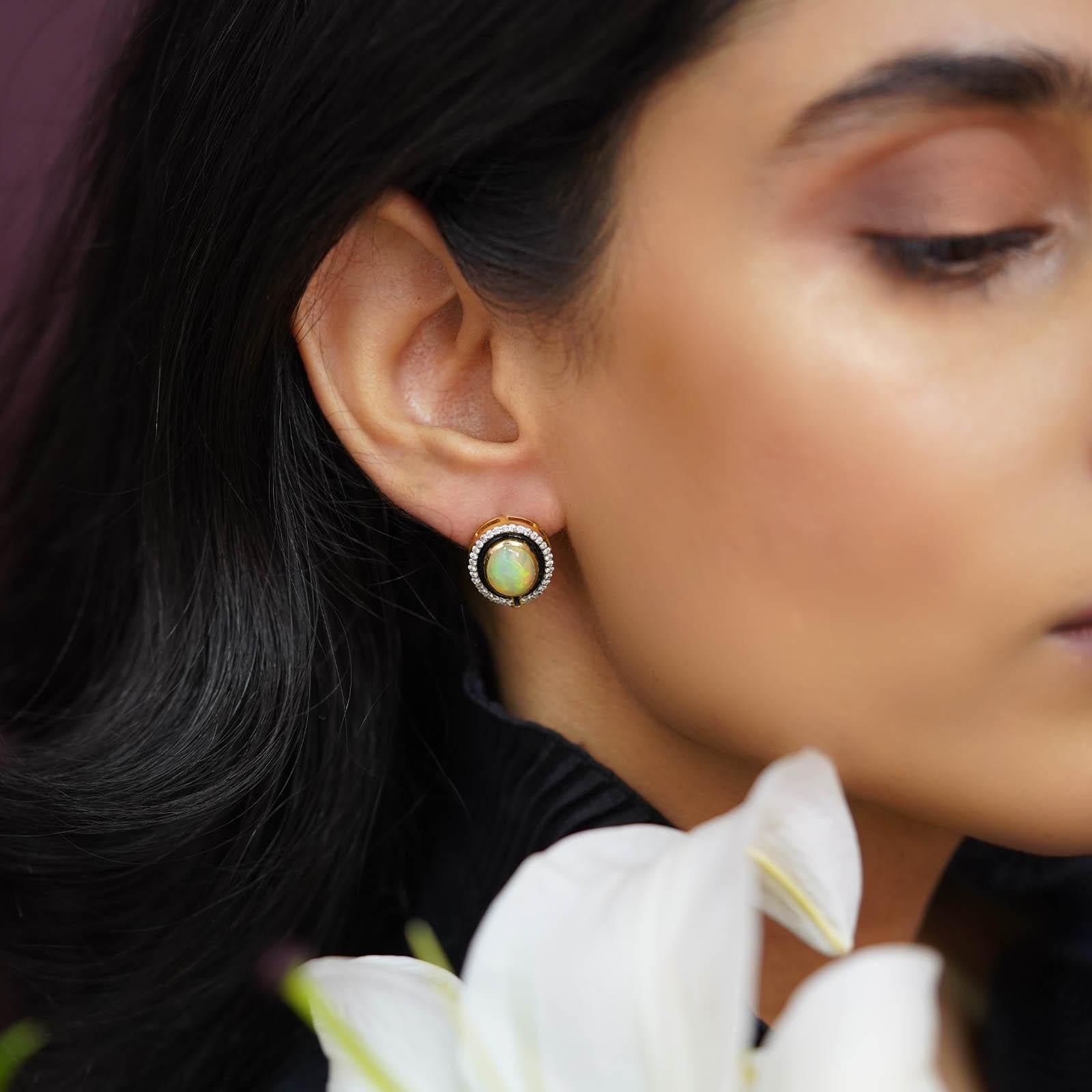 Beautifully handcrafted in gold, they hold a stunning opal in the centre lined with black enamel and brilliant cut diamonds.

Gold(14K) : 4.57g
Brilliant cut Diamonds : (SI clarity & H - I colour) : 0.42 ct
Gemstones : Opal
Other : Black Enamel