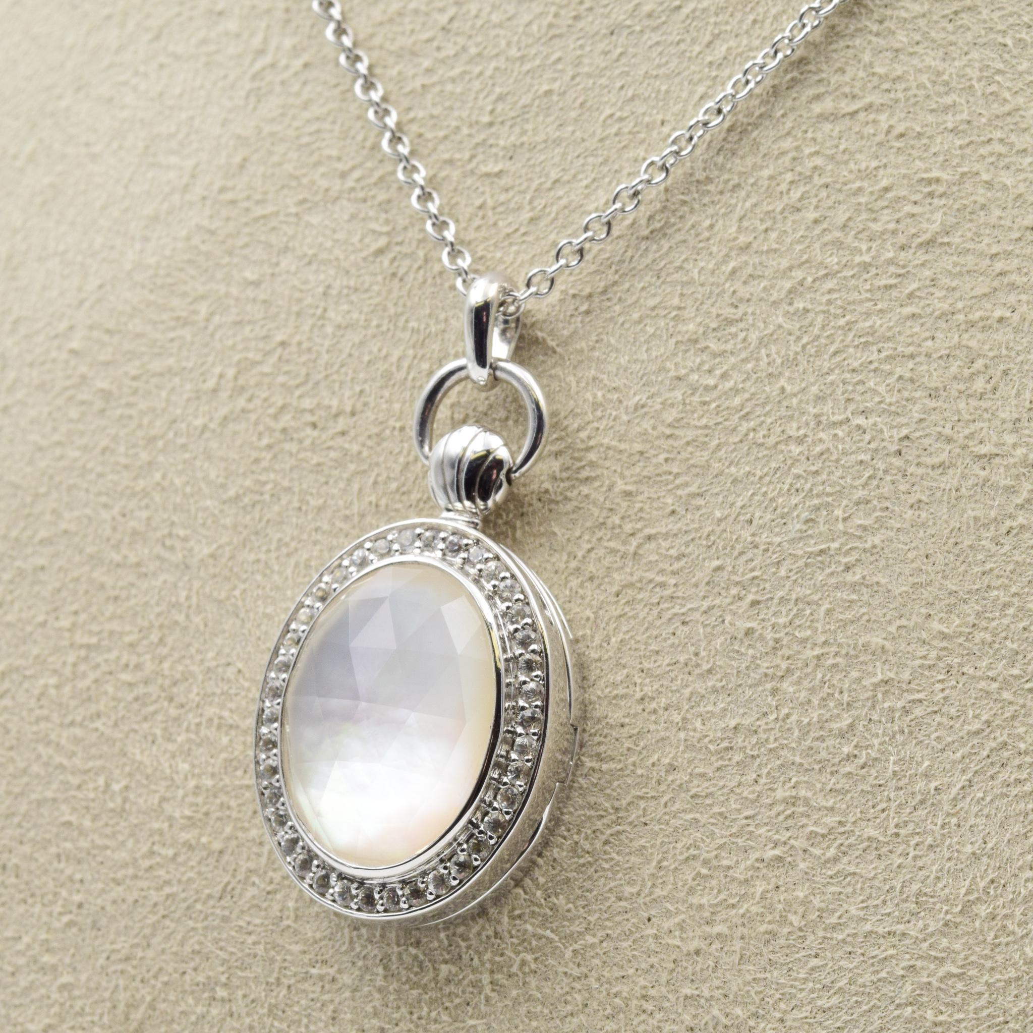 Sterling Silver
Set with Center Rock Crystal or Blue Topaz over Mother of Pearl and White Sapphires
18” Sterling Silver Chain
Locket Measures 1.18