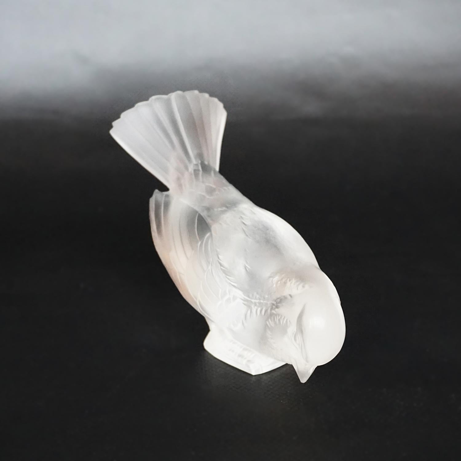 Moineau Hardi, an Art Deco glass bird paperweight by René Lalique (1860-1945). A frosted glass figure of a sparrow pecking for food. Model number 1150. Stencil etched R Lalique France to underside. 

Literature: Marcilhac, R Lalique Catalogue