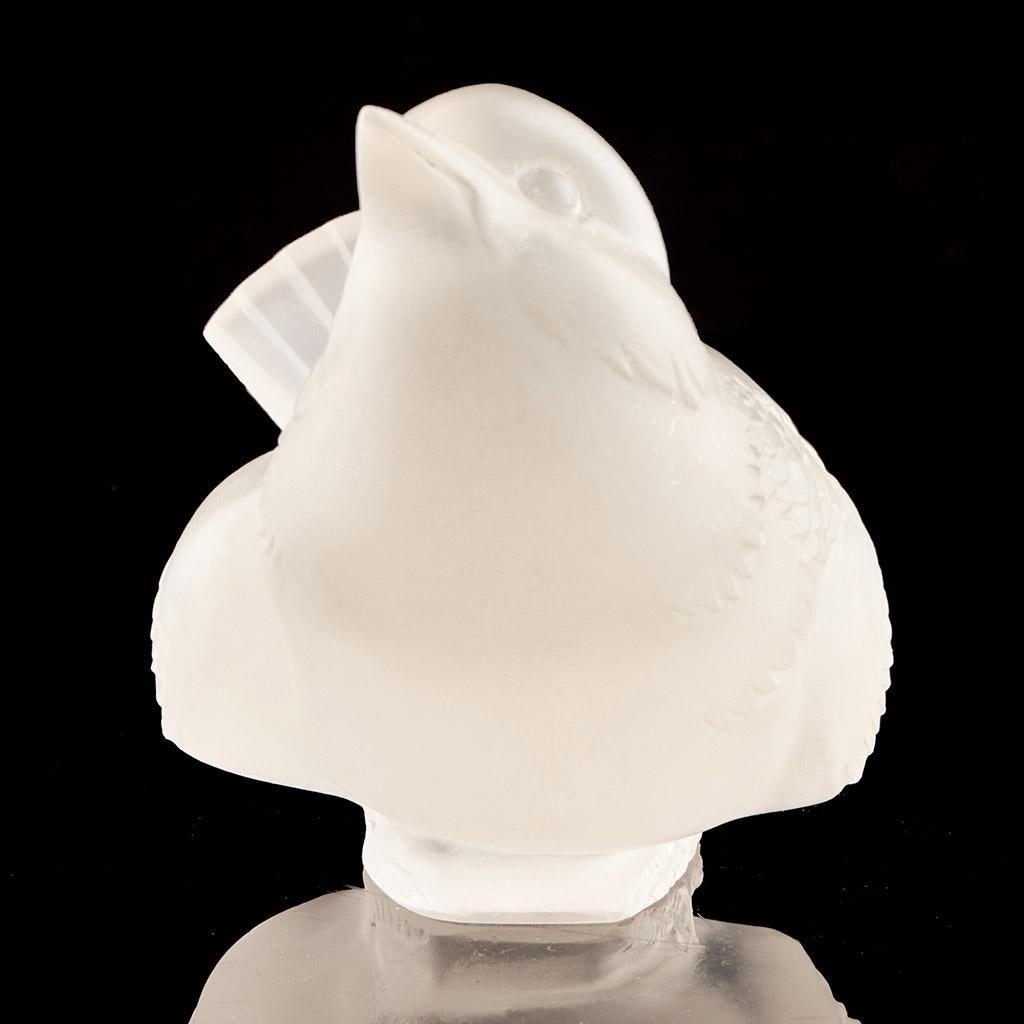 Moineau Moqueur, an Art Deco glass bird paperweight. A frosted glass figure of a sparrow pecking for food. Stencil etched R Lalique France to underside.

René Jules Lalique (French, 1860–1945) was a renowned jeweller and master glassmaker. As one