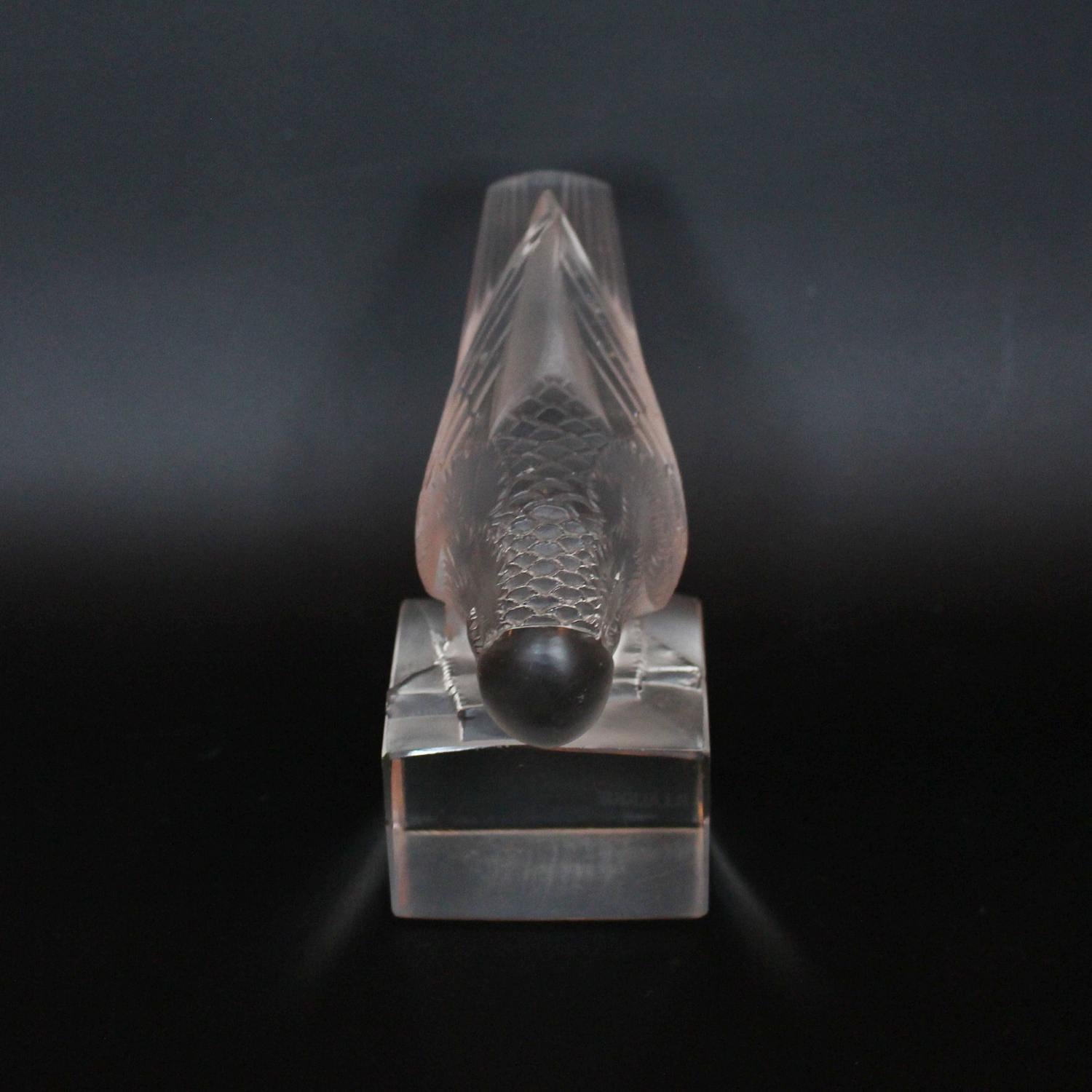 Moineau Sur Socle, Ailes Fermé an Art Deco glass paperweight. A frosted and clear glass figure of a sparrow pecking for food, set over a clear glass base. Model number 1156. Literature: Marcilhac, R Lalique Catalogue Raisonné de L’Œuvre de Verre