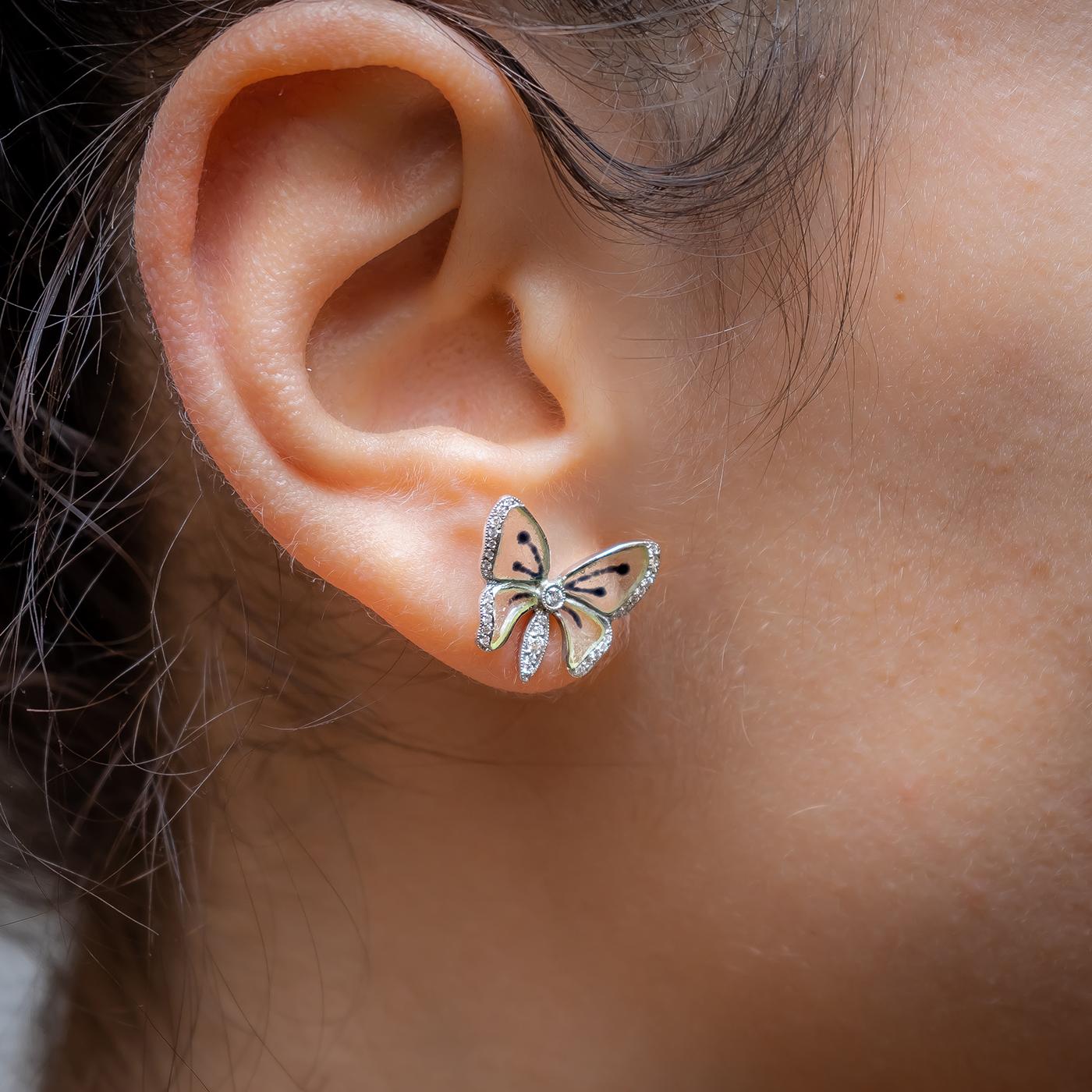 A pair of Moira blue butterfly earrings, with light blue, plique à jour, enamel wings, with black veins, with round brilliant-cut diamonds, set in the thorax, abdomen and wing edges, mounted in 18ct yellow gold, with alpha clip fittings.