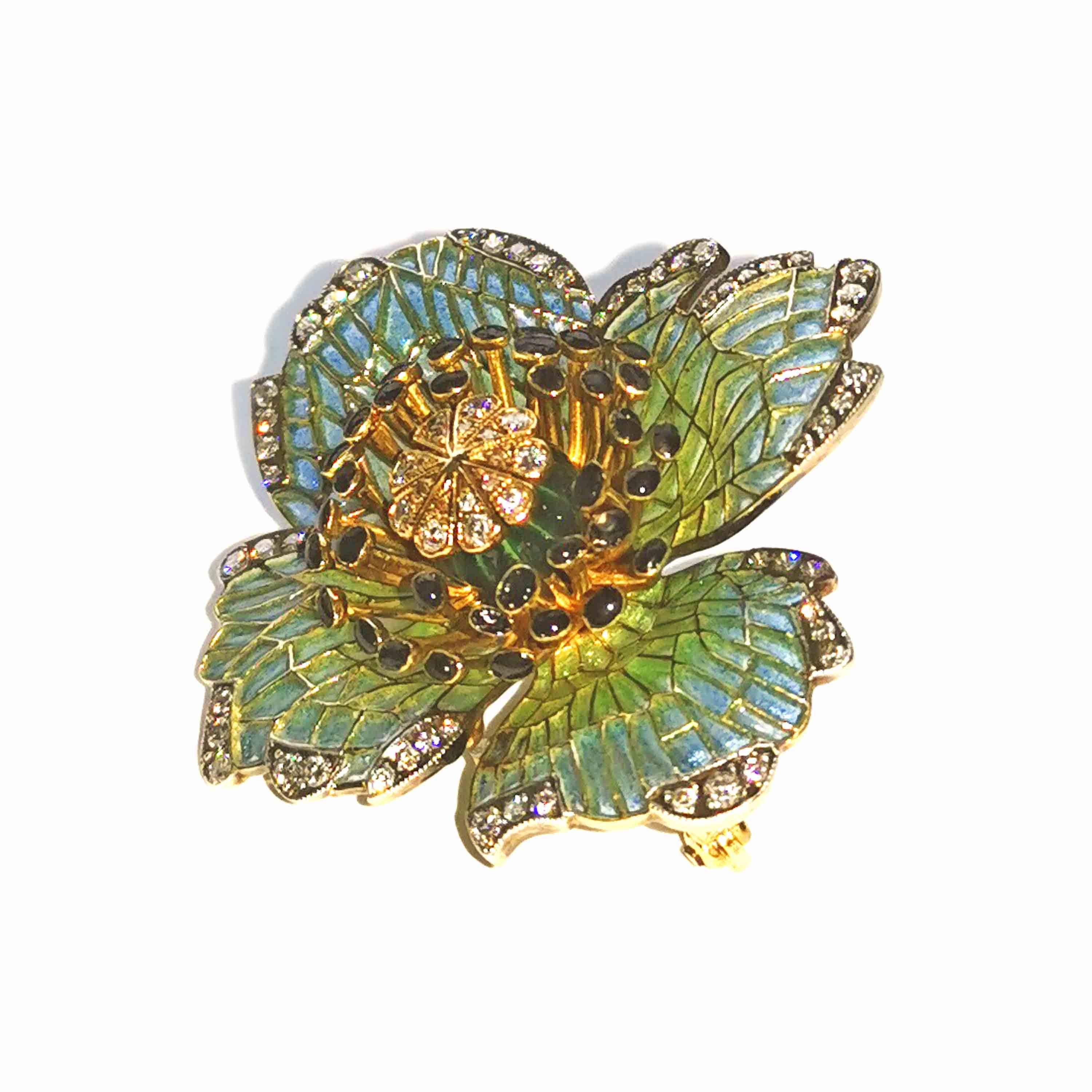 A Moira design poppy brooch, with blue to green plique a jour enamel petals, black enamel stamens, with a green enamelled pistil, set with round brilliant-cut diamonds, mounted in gold, with silver settings, with a roller catch fitting.


Moira’s
