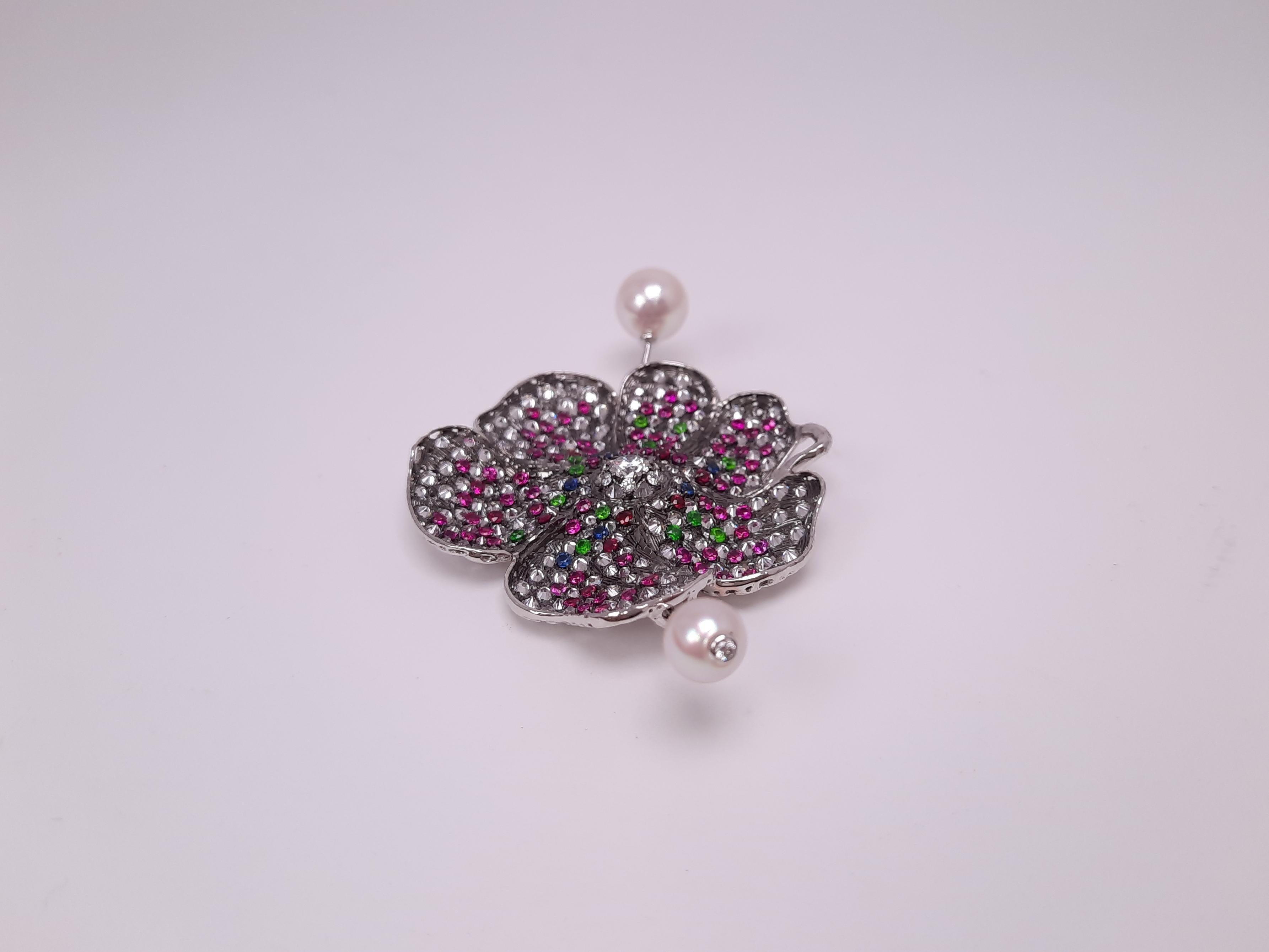 Over 4 ct diamonds, radiant demantoid garnet, precious rubies and sapphires made a great harmony on a handmade poppy flower. Setting stones upside down alternatively, the broach gives unusual luminescence. Handmade flower petal is so lively. The