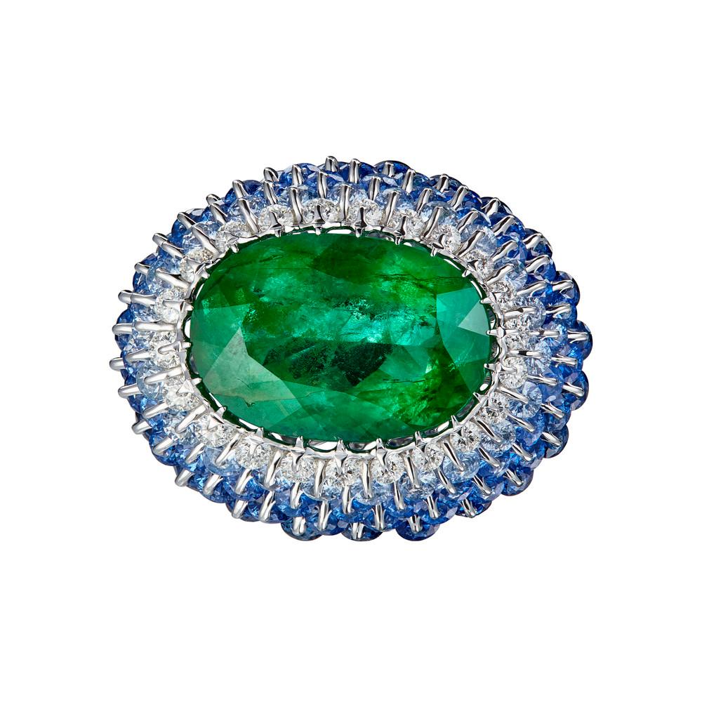 9.25ct oiled Emerald  is mounted in a classical yet state of the art technology jewellery frame.  Over 6ct precision cut sapphires are carefully selected and located to make the perfect colour graduation to emphasize the colour of the central