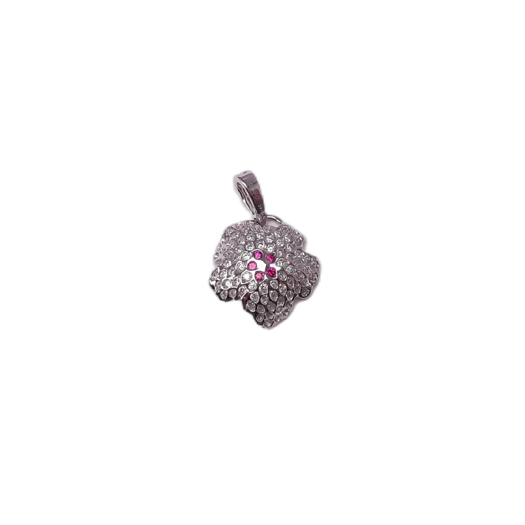 A floral pendant consisting of 18K white gold, 0.755ct diamond, 0.09ct Rubies presents your look elegantly and charmingly. The lively floral petal is embedded with inverse diamonds, which reflect the light. Rubies are also mounted inversely, shaping