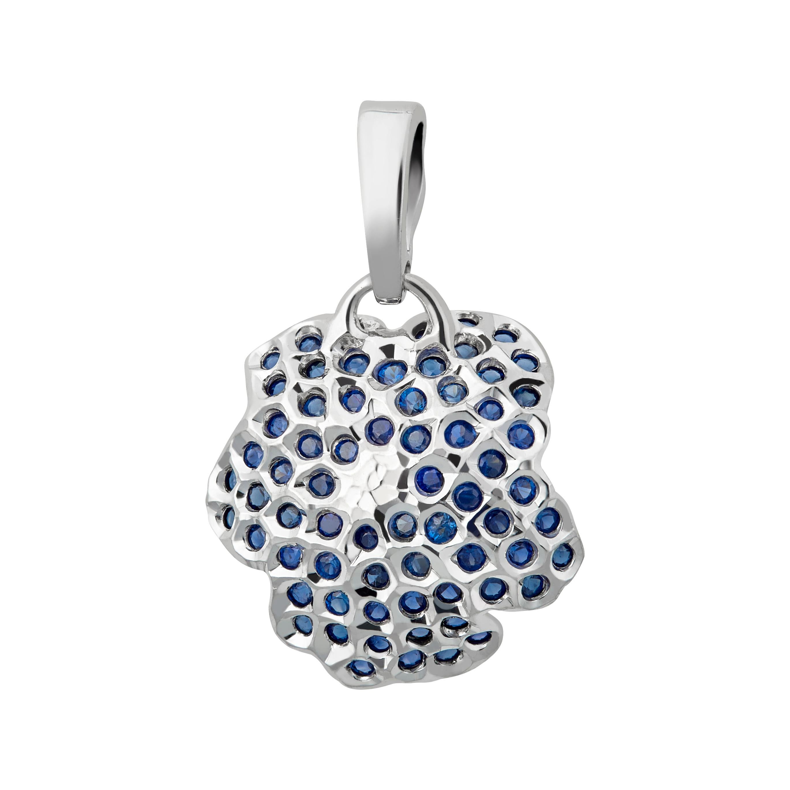 A floral pendant consisting of 18K white gold, blue sapphires and 0.32ct diamond presents you elegantly and charmingly. Diamond slightly show blue tint due to the unique shinning effect from reversely mounted sapphires. An interesting reflection of