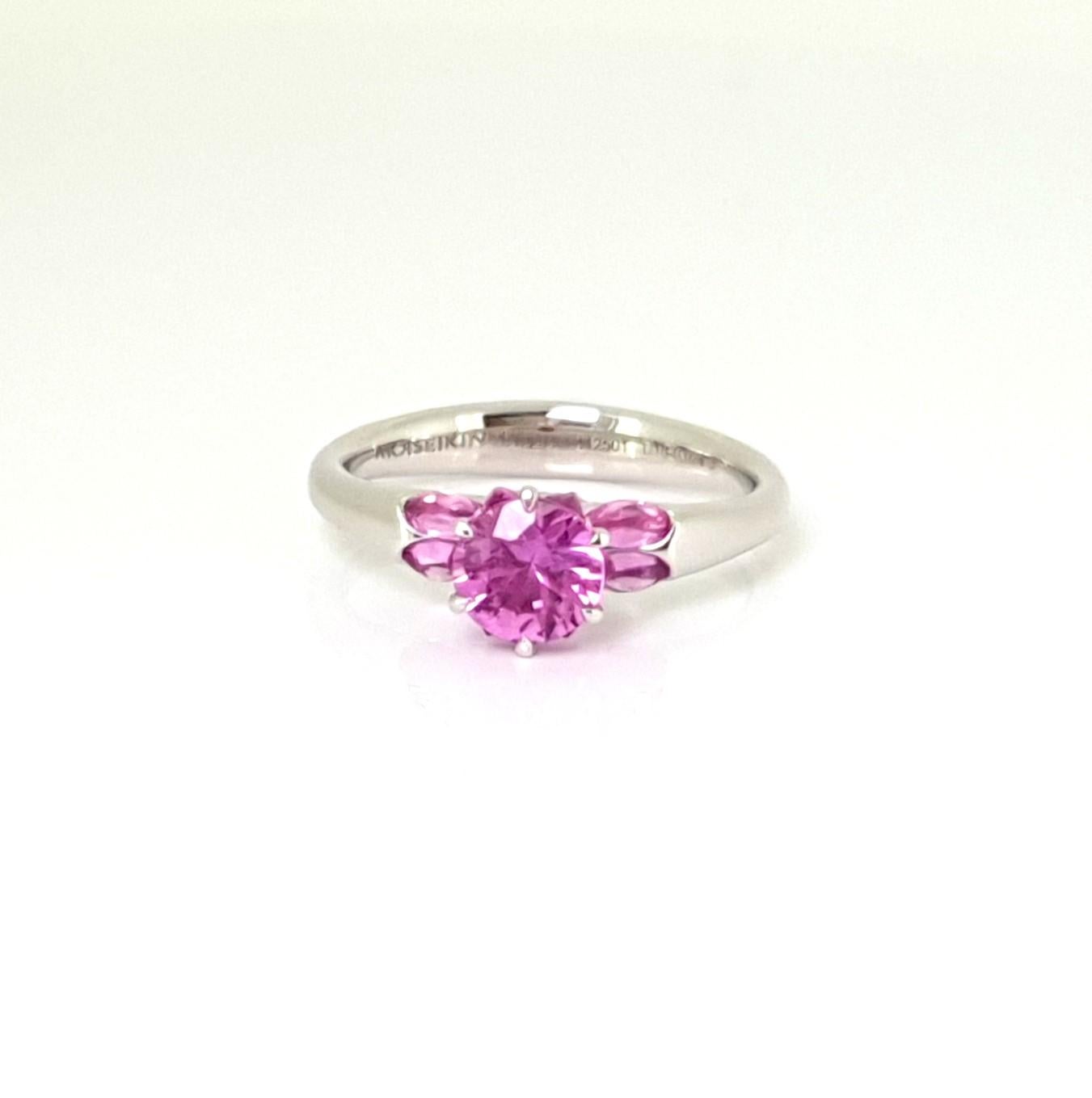 Made from 18K white gold, the Lotus Ring from Moiseikin's Harmony of Water collection exudes elegance and grace.
At its heart lies a captivating 1.01 ct pink sapphire, cradled by six petal-like fancy sapphires in a reverse setting. This unique