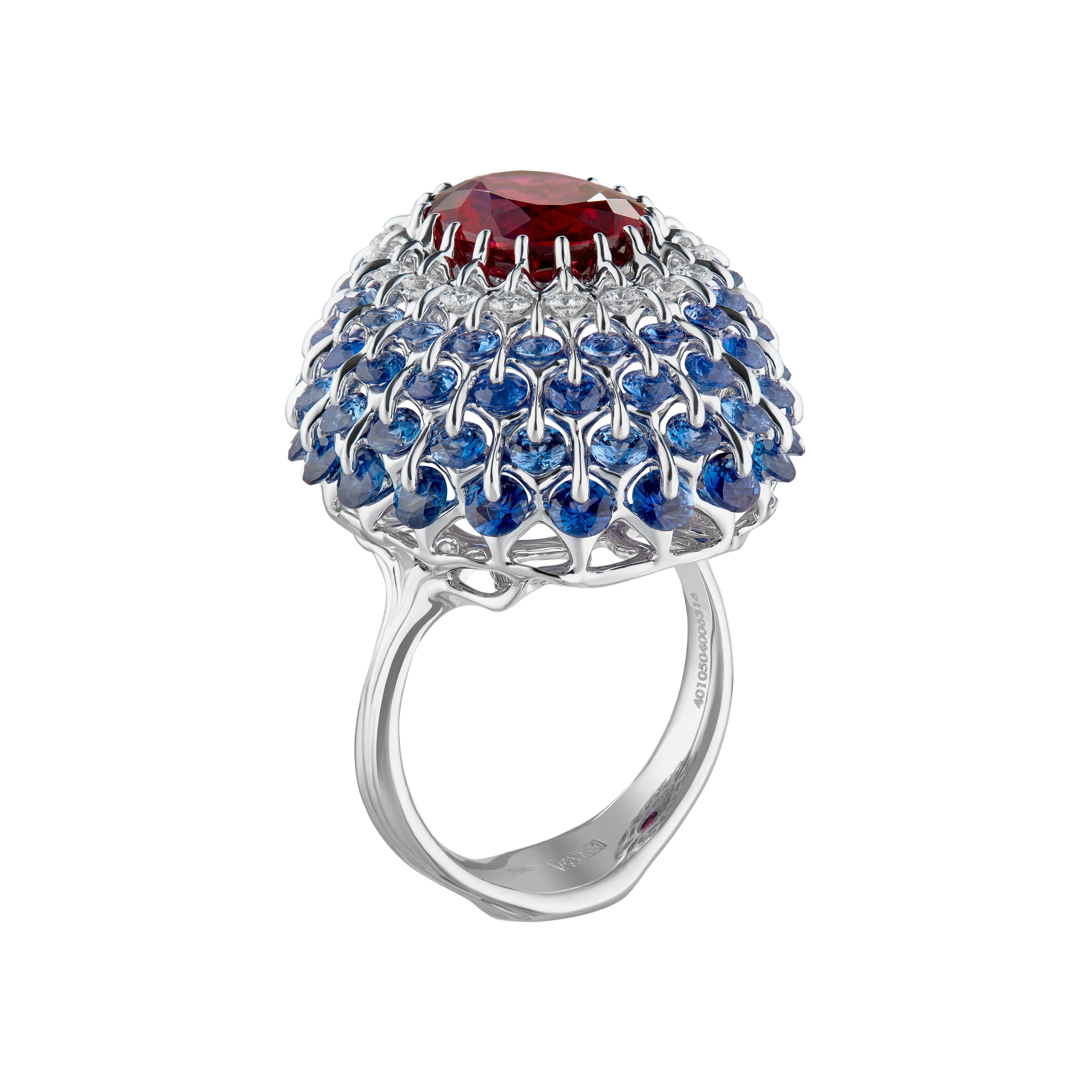 4 carat deep and clean rubellite tourmaline is mounted beautifully in the perfect graduation of diamond and blue sapphire frame. Blue sapphires also cut in diamond shape precisely and carefully selected to make a ball dress-like design (Ball of