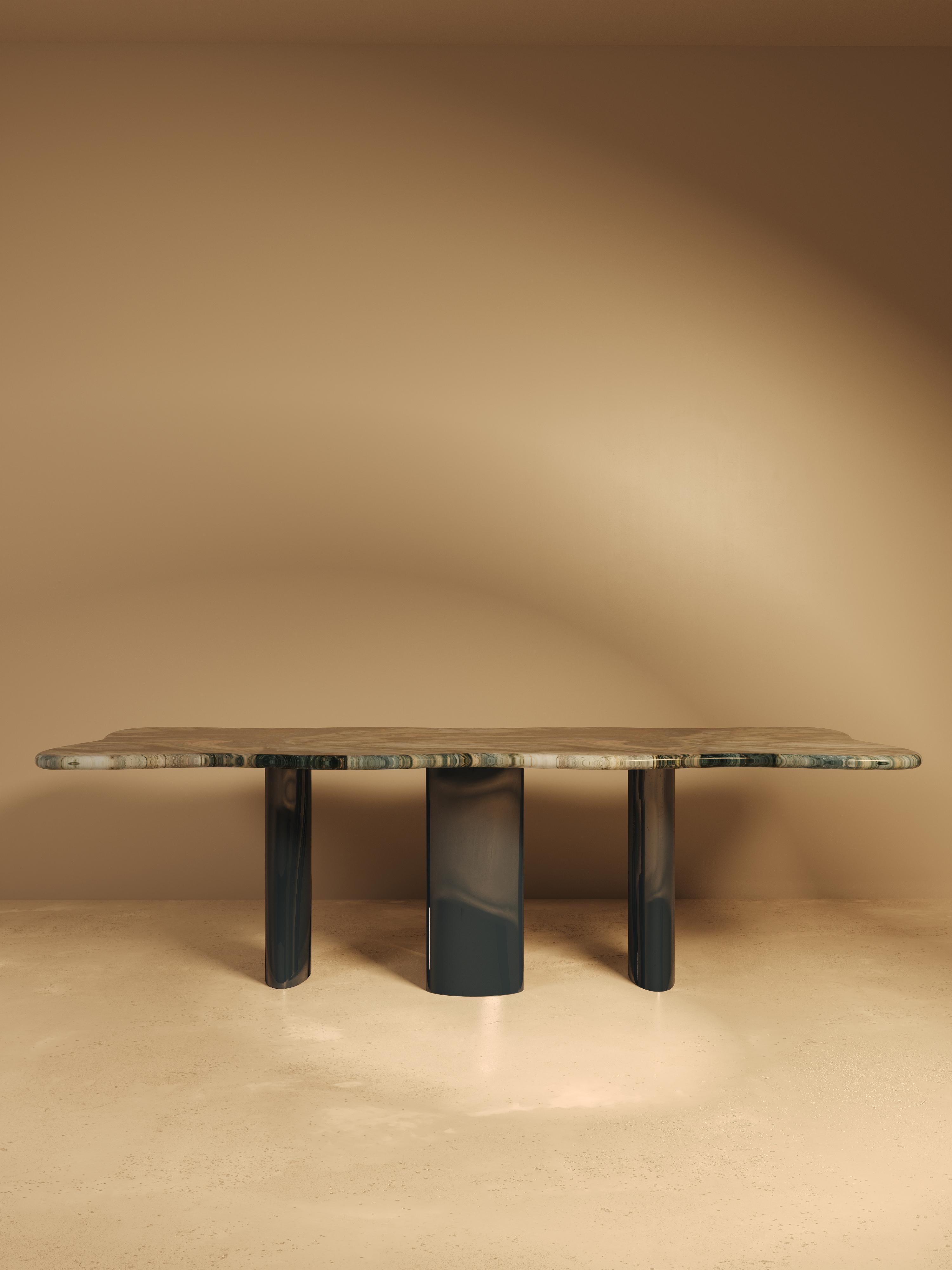 This piece is sculpted from Quartzite Blue Blend, a richly layered natural stone sourced from SolidNature. Its surface reveals a flowing palette of deep blue, olive green, cream, and rust, creating a sense of movement captured in stillness. Because