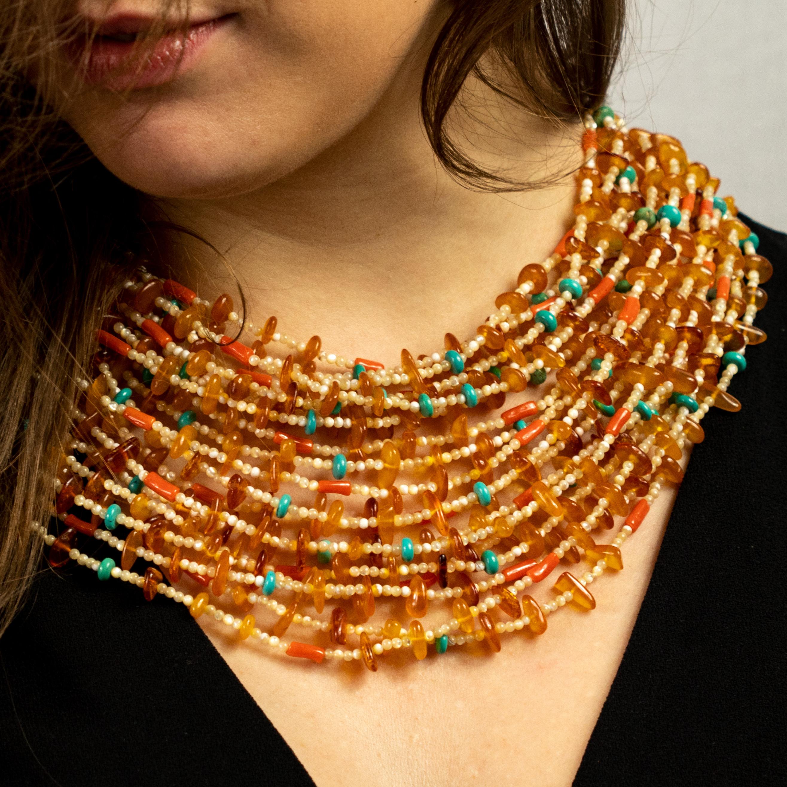 This epic statement neckace is an outstanding display of color and Italian craftsmanship where moka mother of pearl, amber, turquoise and coral melt in one-of-a-kind piece.

This necklace is inspired by the Egyptian jewelry worn by the pharaohs.