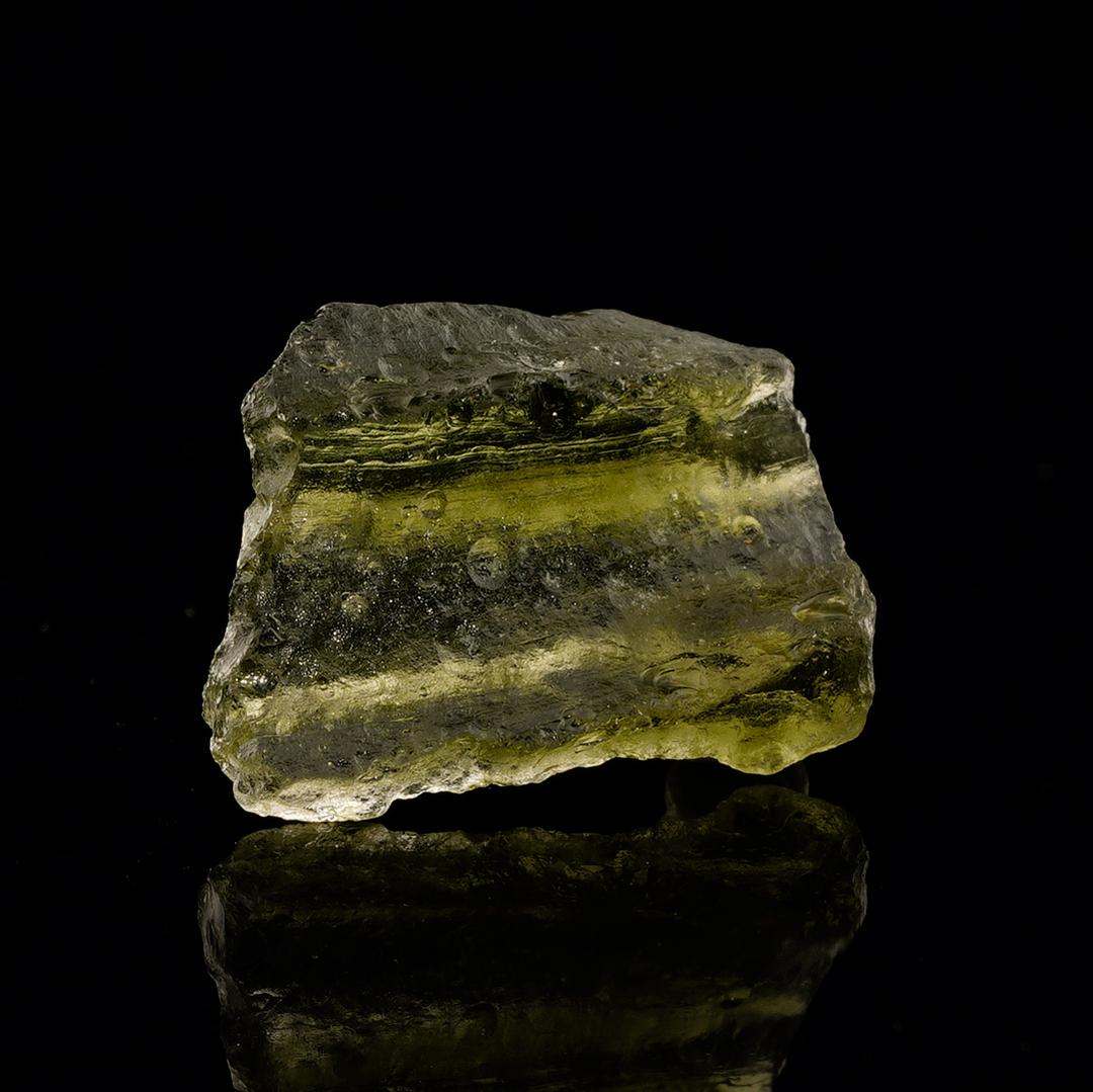 This genuine moldavite in stellar condition offers a luminous green color and fascinating natural texture, making it an overall great specimen. Moldavite is one of the most sought after of all tektites.

Approximately fifteen million years ago, a