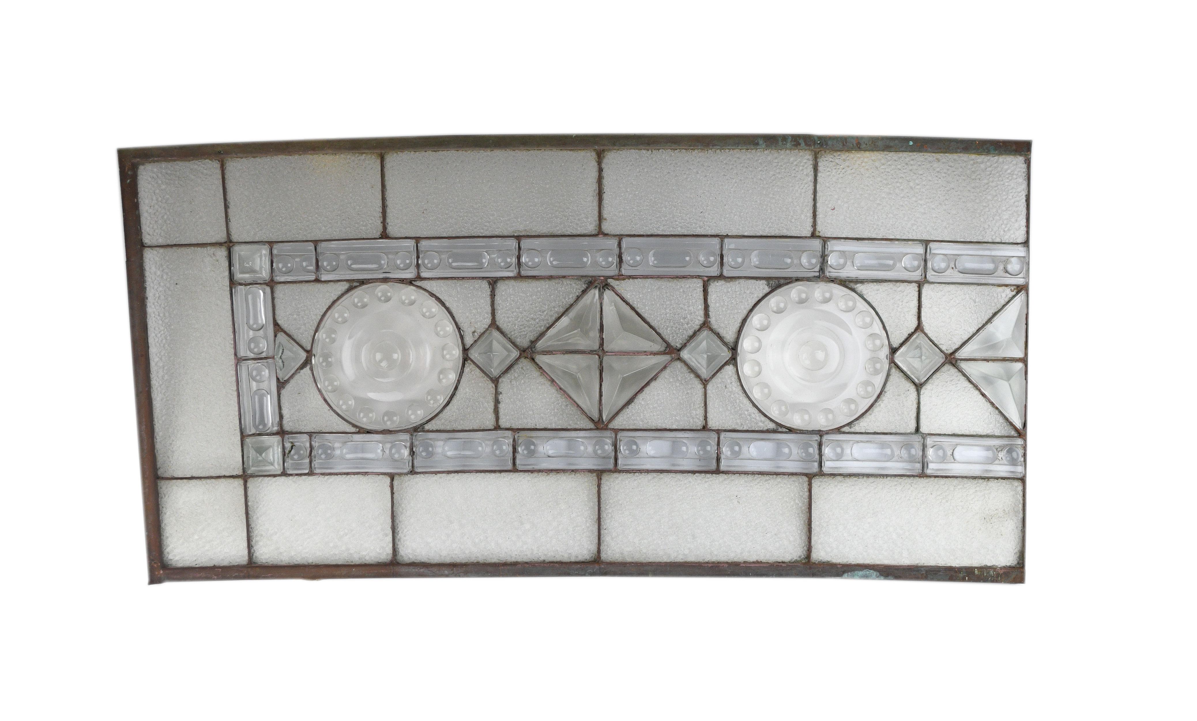 This stunningly crafted window features geometric molded glass on handsome textured glass. A symmetrical mix of sharp lines and curved shapes give each of the 4 pieces of this massive window a unique look.