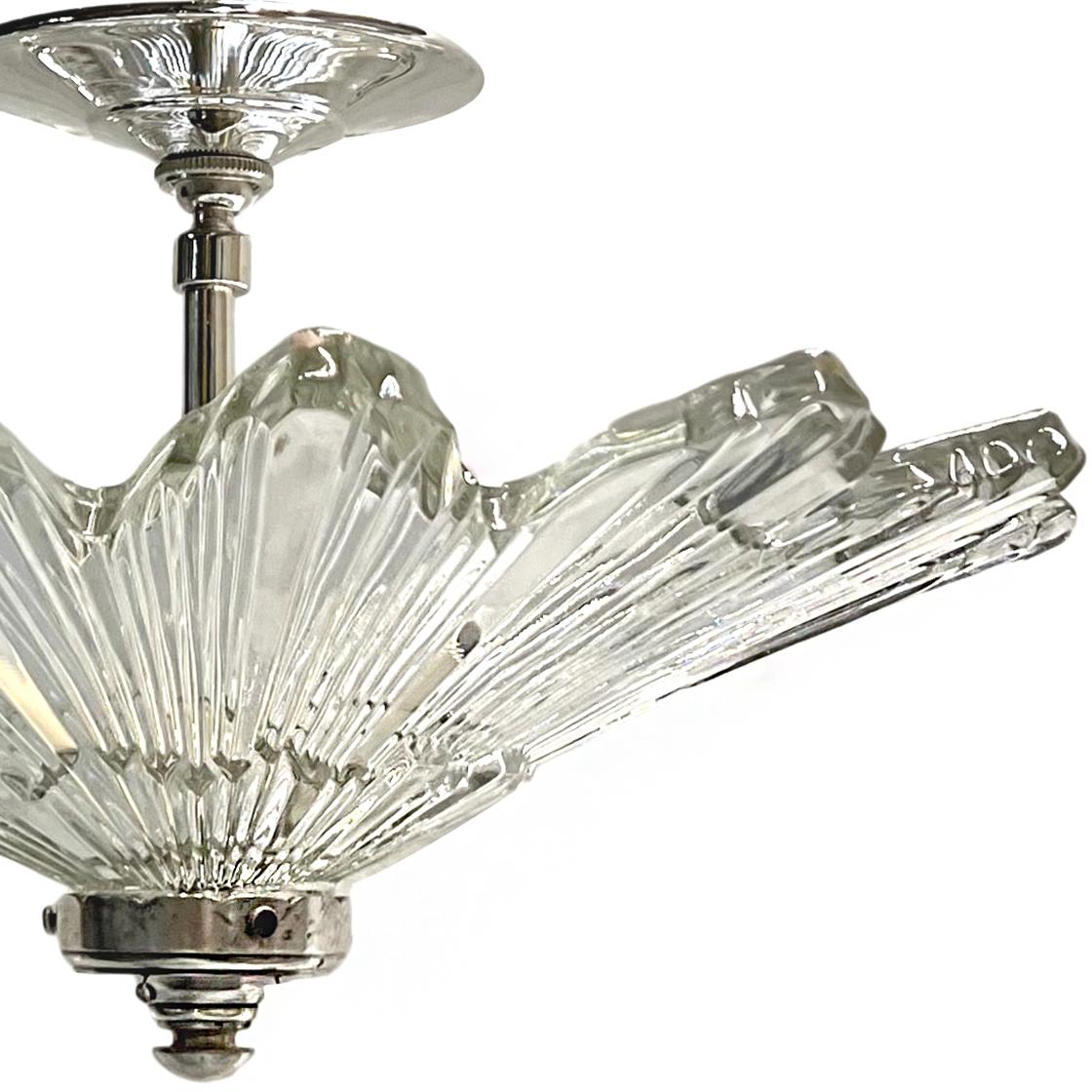 A circa 1930’s molded glass light fixture.

Measurements:
Diameter: 16″
Drop: 10″
