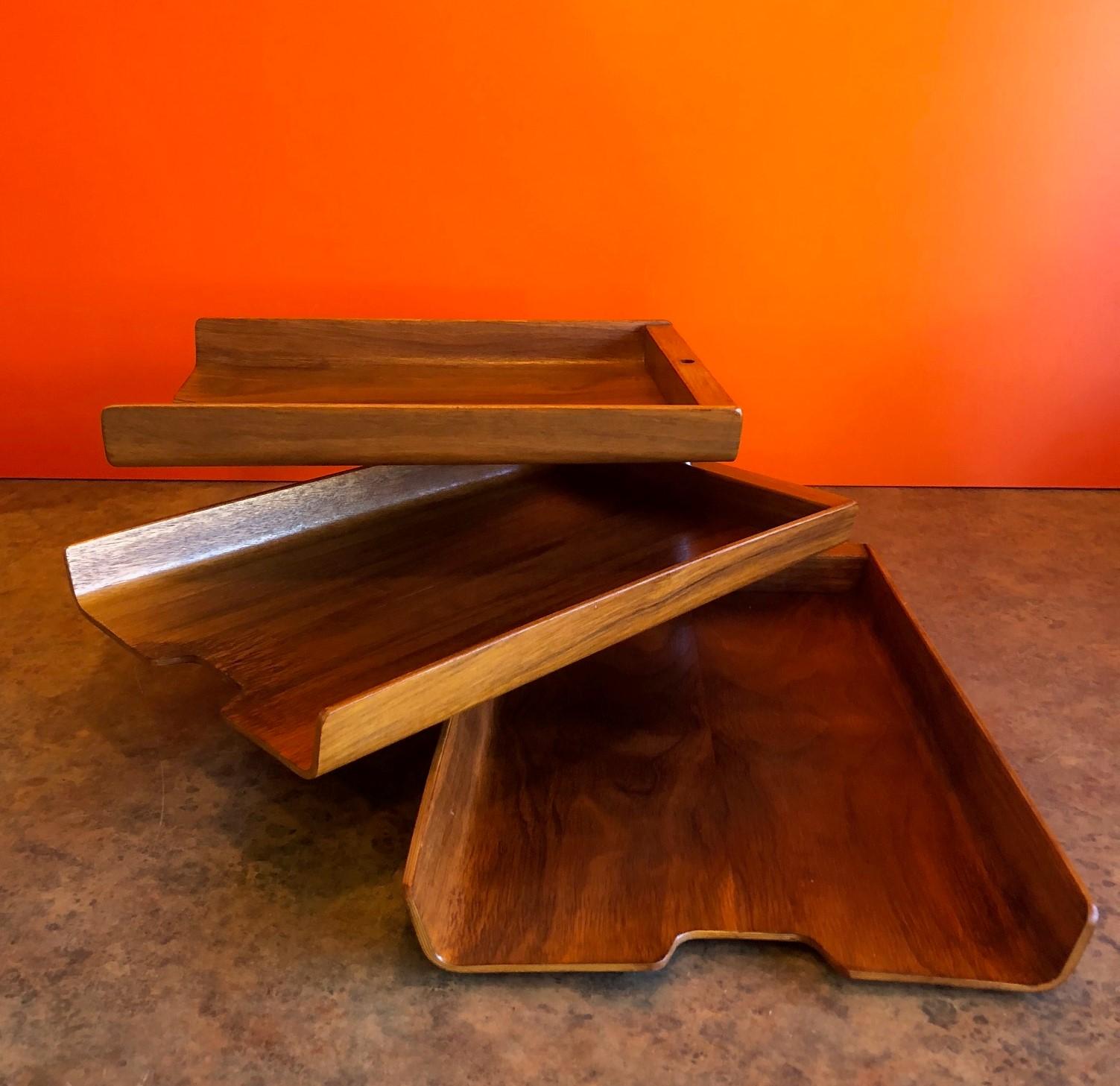 Very cool and functional triple letter tray by Martin Aberg for Rainbow Wood Products Company of Sweden, circa 1960s. The trays are made of molded teak plywood and can swivel into any number of configurations to meet your office needs. The set is in