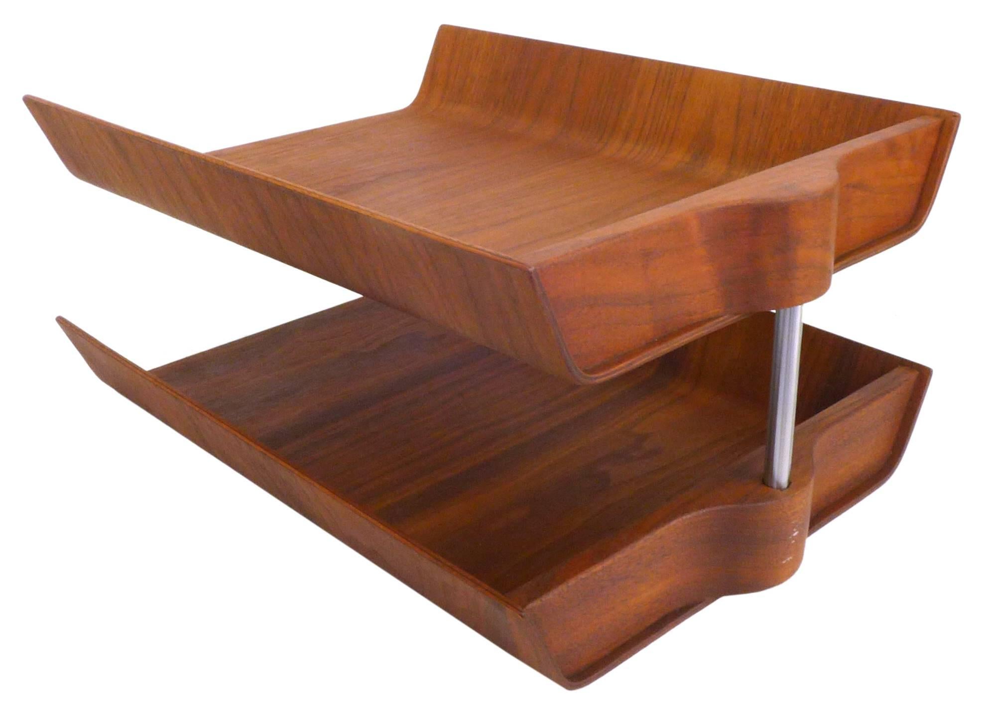 An architectural, two-tier, molded walnut plywood letter tray by Florence Knoll. An outstanding desk accessory as beautiful and iconic as it is practical. An American midcentury classic in wonderful original condition retaining Knoll label at the