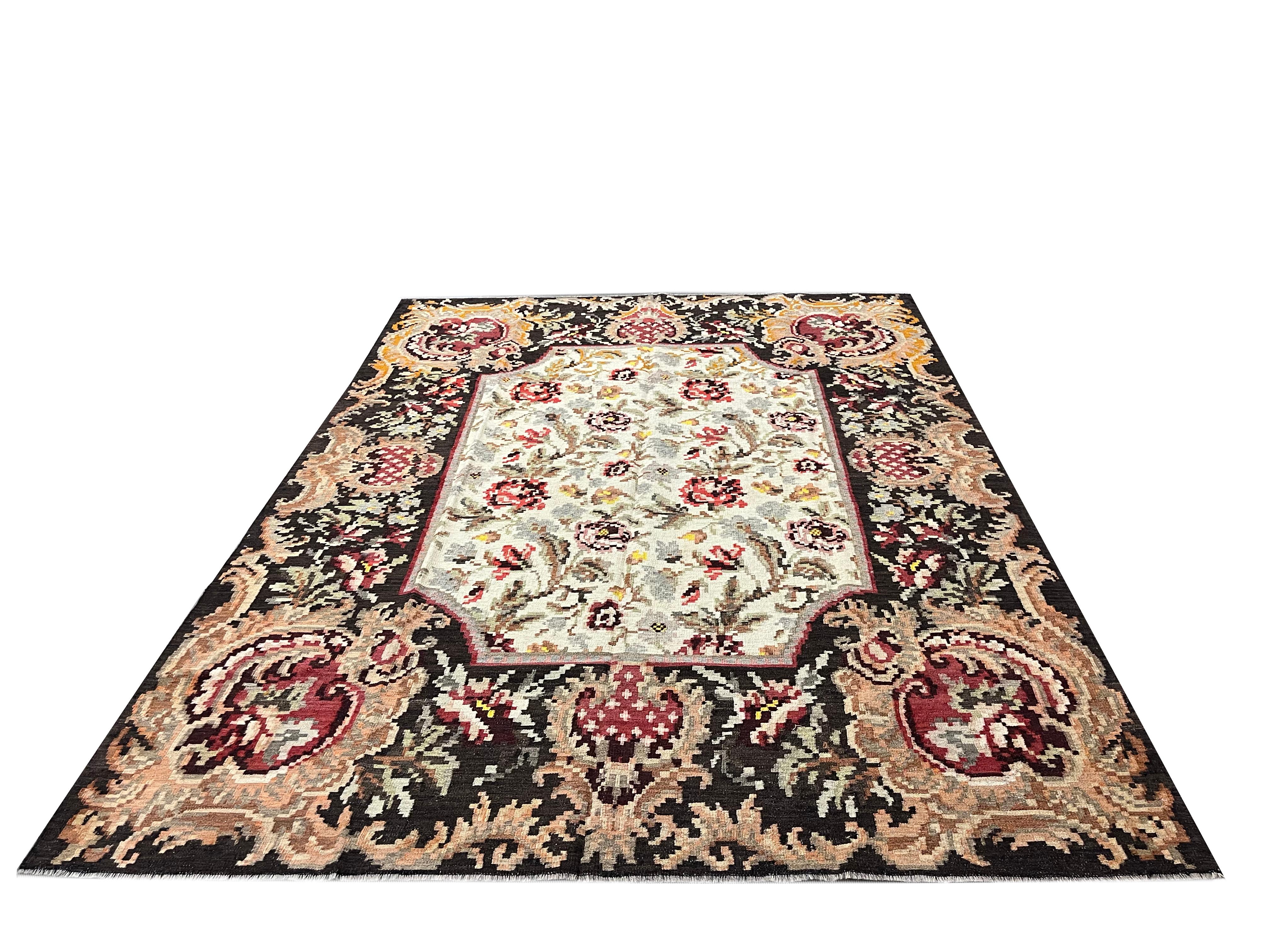 This beautiful handwoven kilim rug is a traditional Moldovian area rug woven in the 1920s. The rustic colour palette includes an array of colours including accents of red, beige, yellow and rust that make up the intricate floral design. The colours