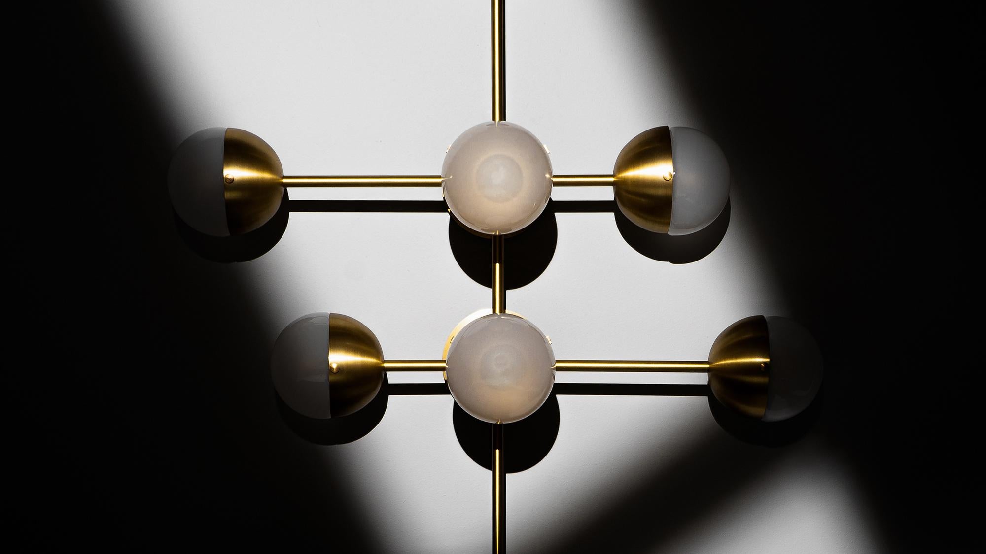 Recalling the basic elements of matter, this wall-mounted molecular model is composed of brass connections. The flush mount base gives this lamp special adaptability, a wall-mounted statement, or a compact chandelier.


Available in our three