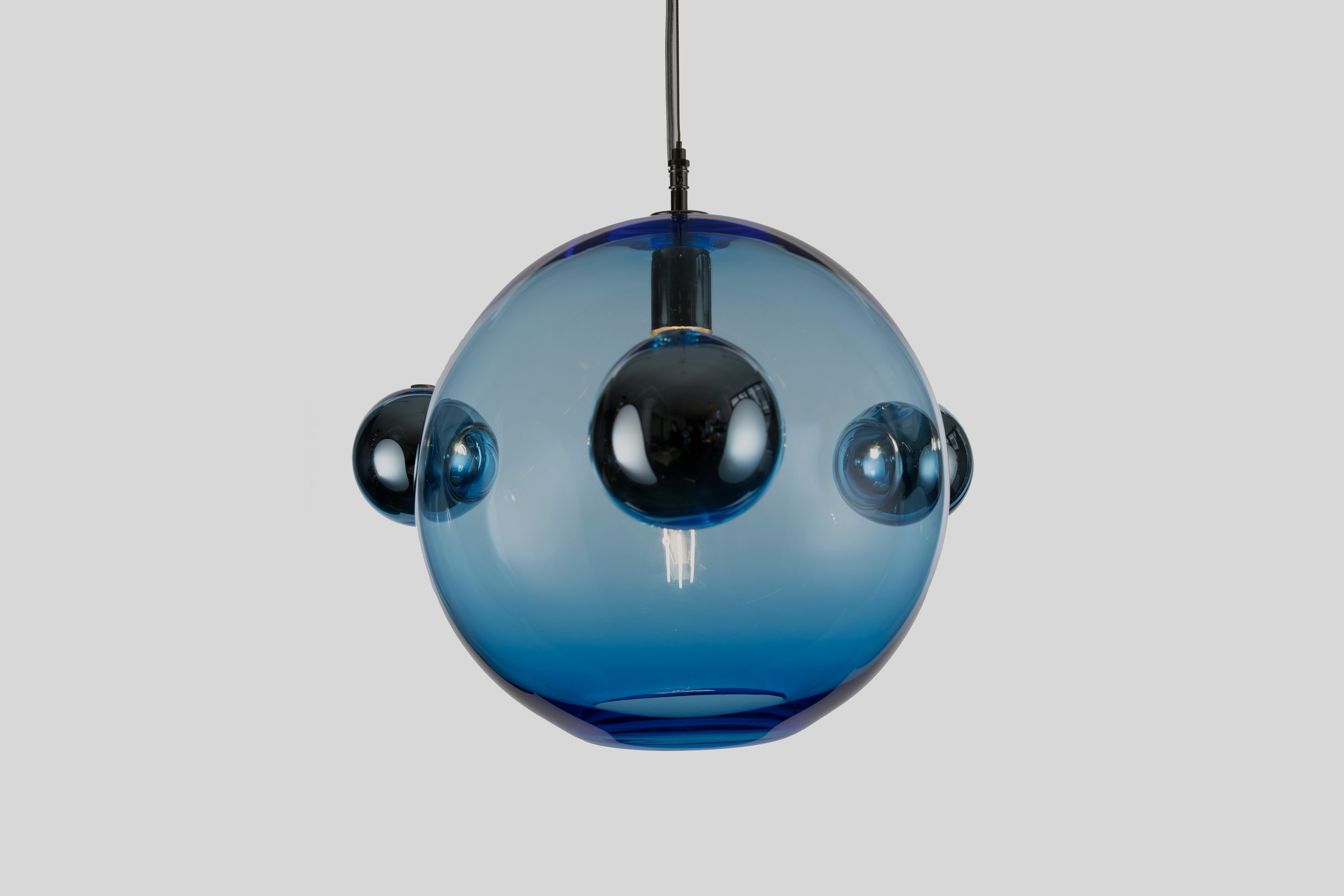 The Molecule Pendant - Triple is a calculated arrangements of handblown glass orbs meant to resemble simple molecular structures. It consists of a 14