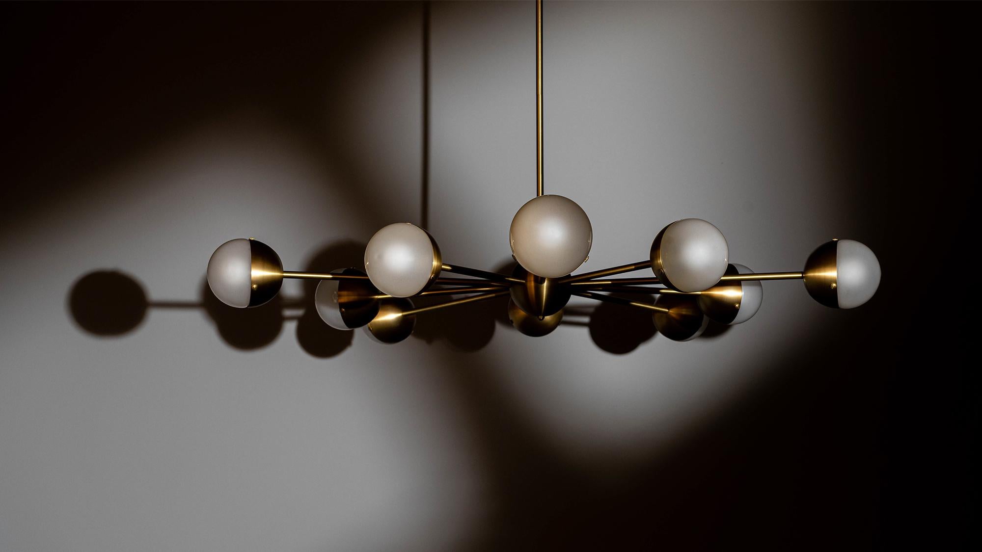 Sparks of light trail brass lines in a circular formation. Radiating out from a spherical nucleus, ten sprightly rods wield illuminated hemispheres, spectacular spatial punctuation.


Available in our three signature finishes: Lacquered Burnished