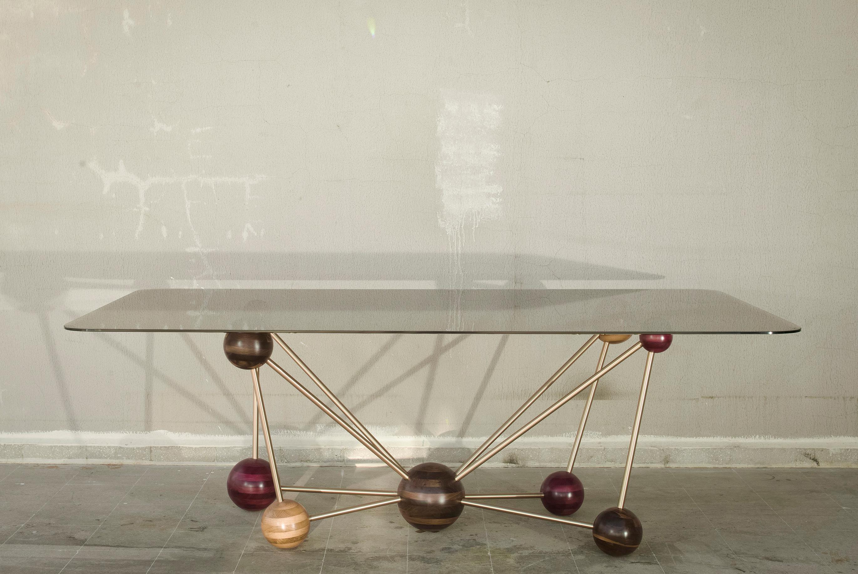 Molecule, Georges Mohasseb Design, 2014
Mixing Art and Chemistry, using natural material and natural alloys to build this beautiful dining table, molecule. For the base, brushed brass sleek rods are connected with perfect round-shaped solid wood
