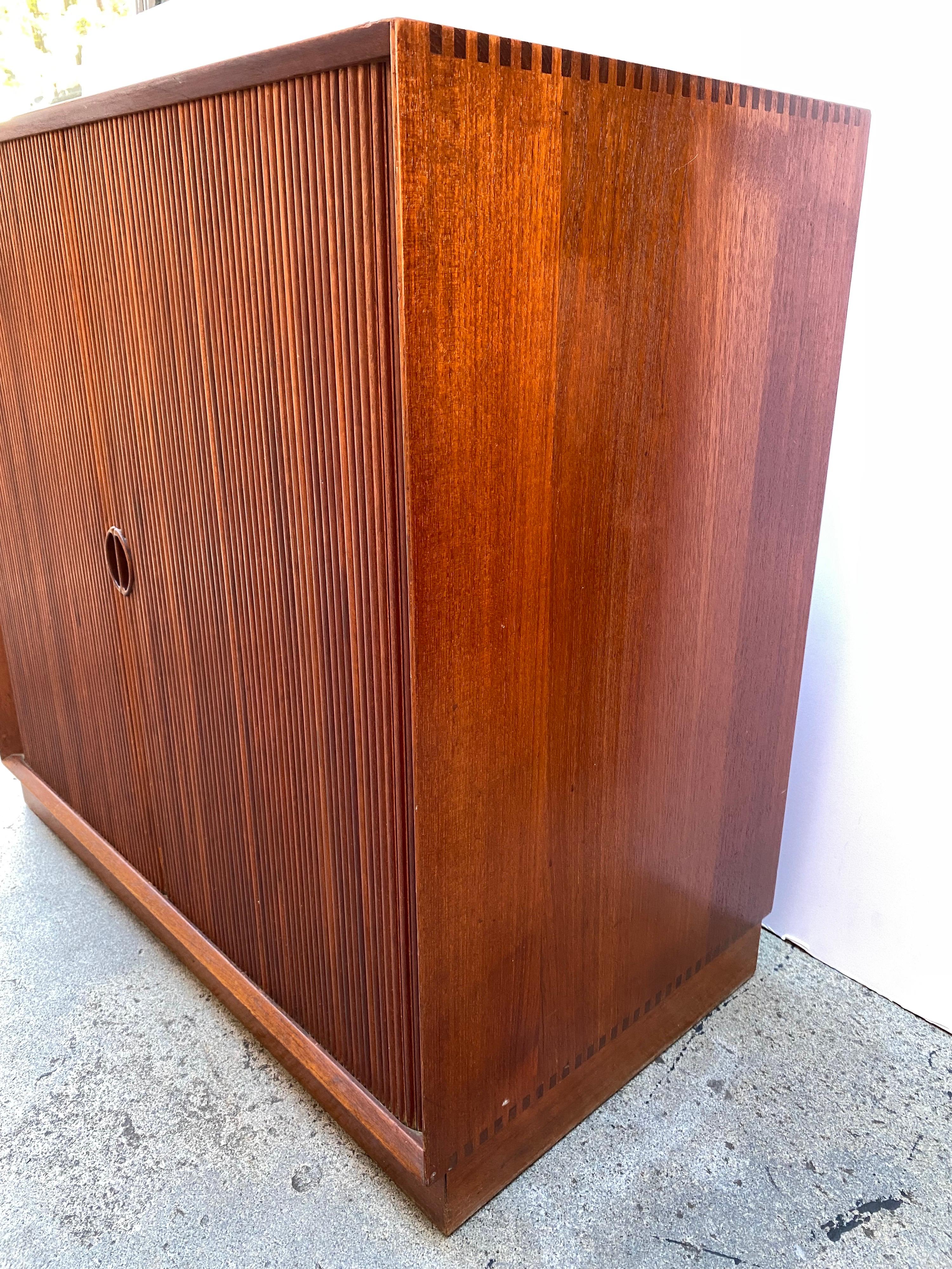 Peter Hvidt Tambour door solid teak cabinet for John Stuart. One of a few companies/designers who produced solid wood teak furniture! Beautiful Dovetailed joints to cabinet! Machines were developed in Germany to produce this beautiful line of