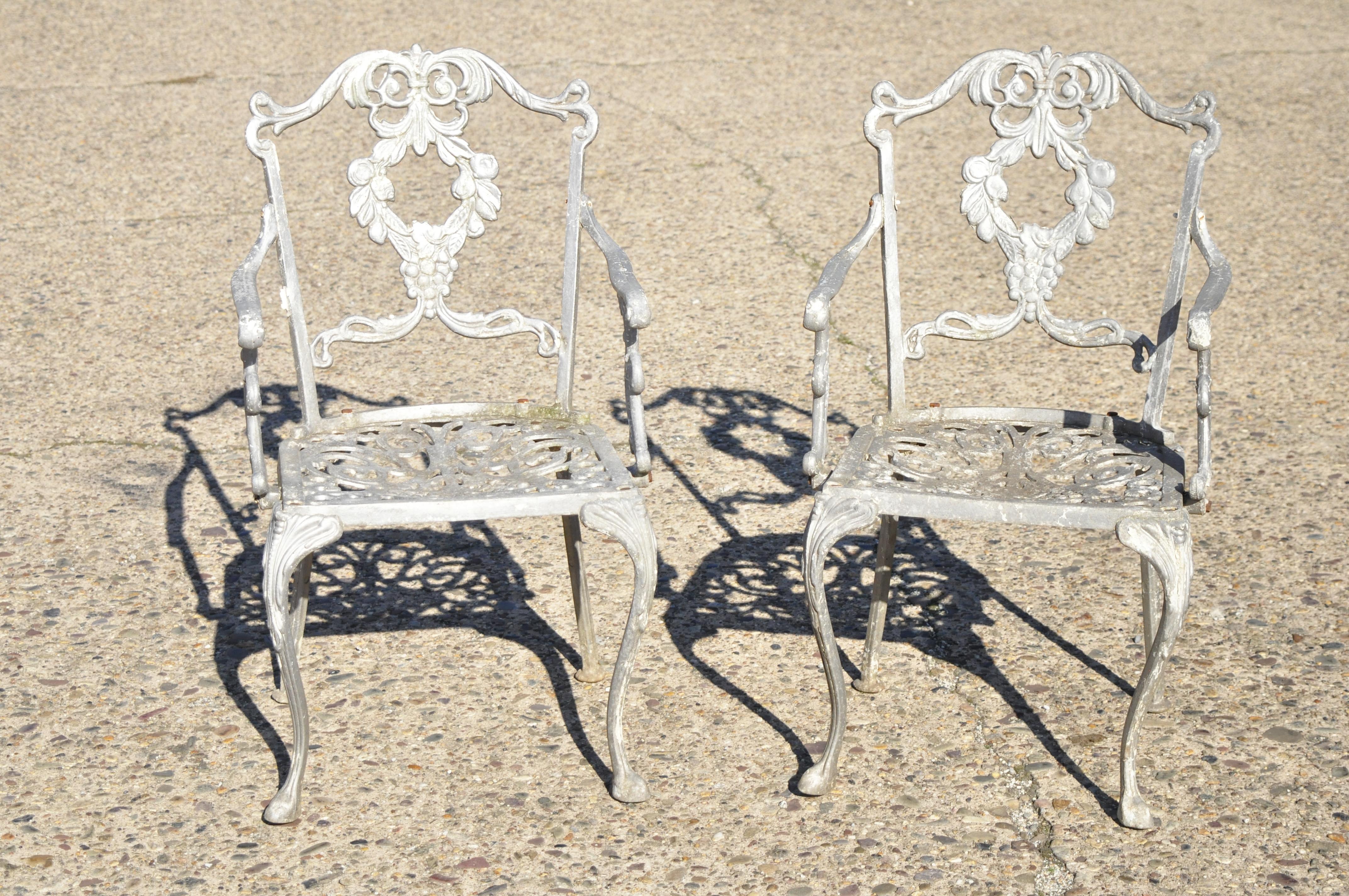 Molla antique French Victorian cast aluminum garden patio Bistro dining set - 3 piece set. Set includes (2) armchairs, (1) round table, cast aluminum construction, leafy scrollwork design, very nice vintage set, circa mid-20th century. Measurements: