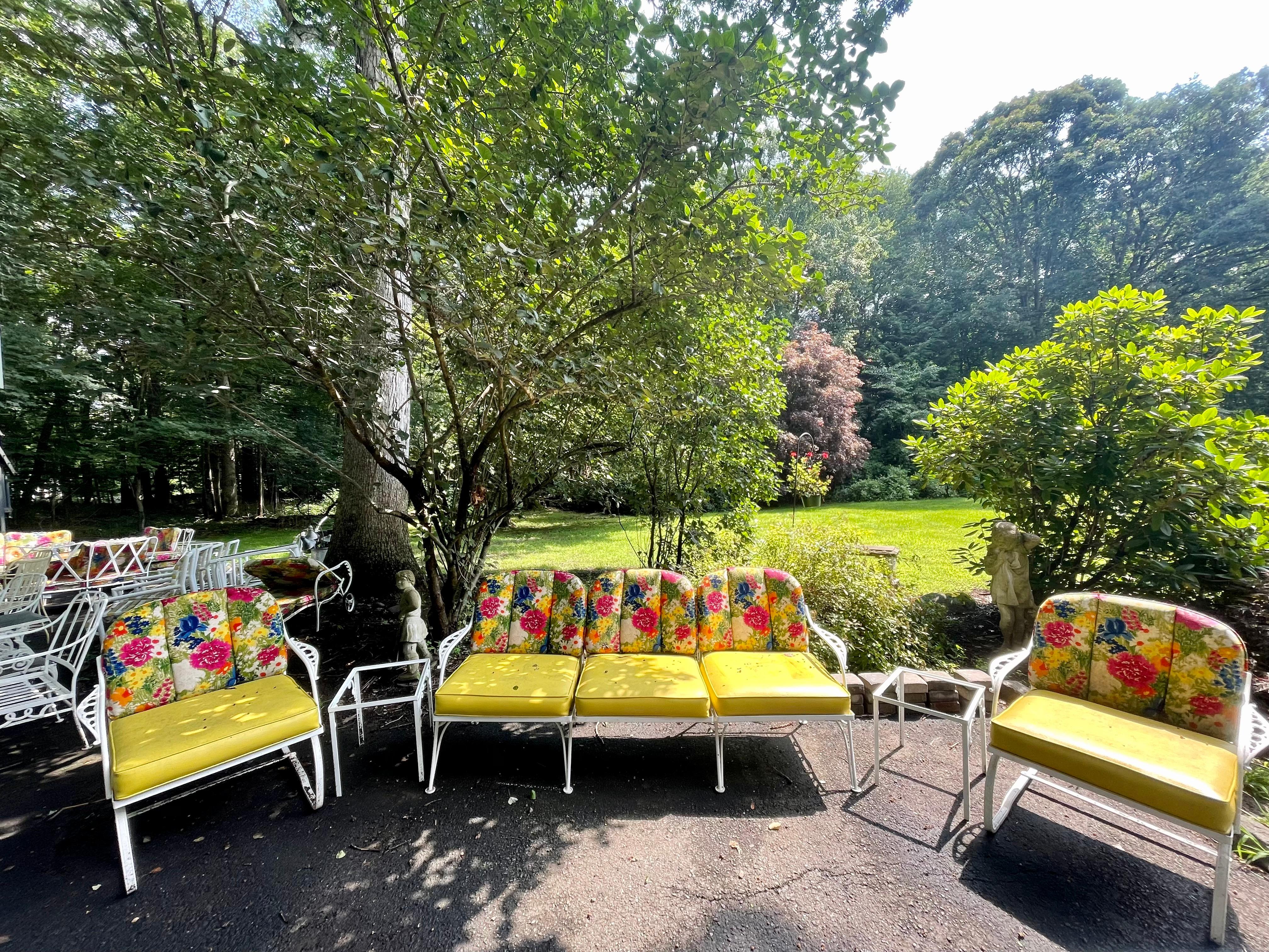 This unique and elegant patio set from The Molla Company was salvaged from an estate in Greenwich, CT. Aluminum furniture with bright yellow and floral cushions. Set includes 1 three seater, 2 club chairs, 2 side tables. Only one owner, in fantastic