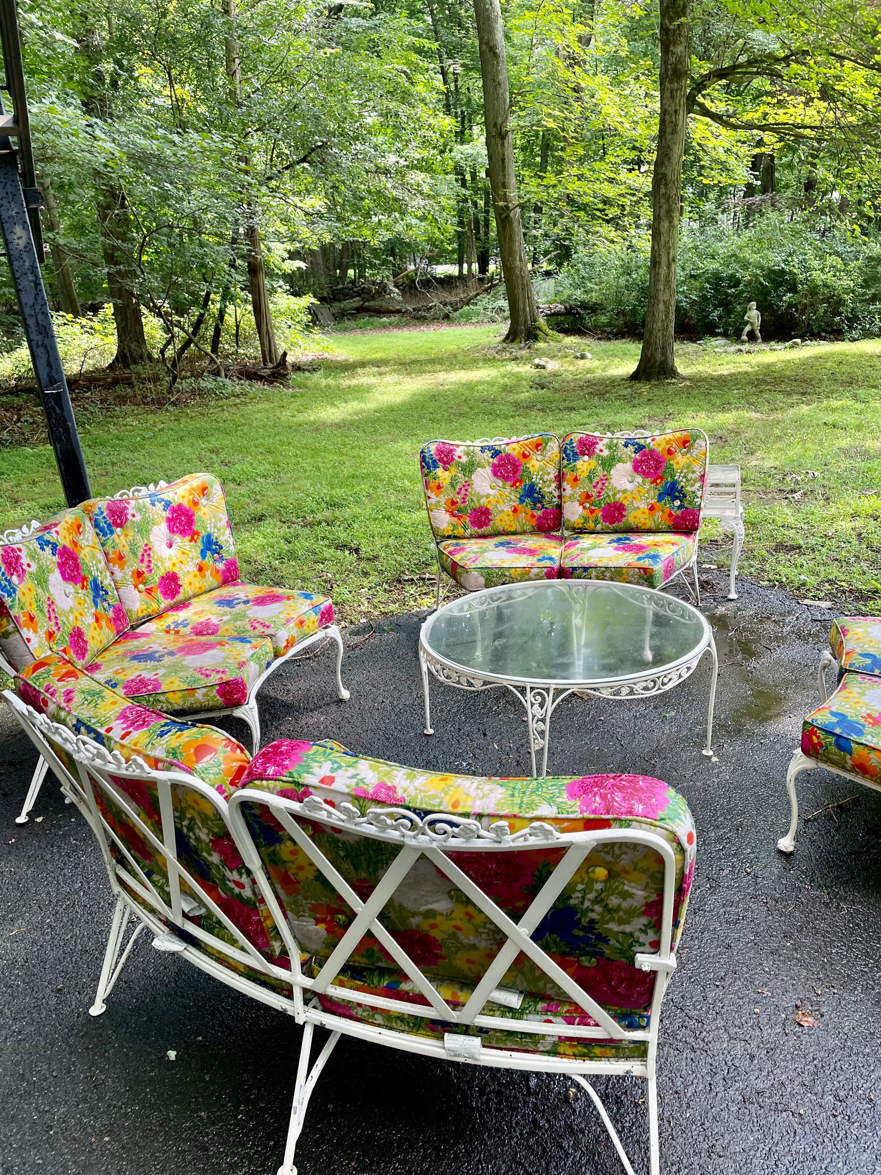 This unique and elegant patio set from The Molla Company was salvaged from an estate in Greenwich, CT. Aluminum furniture with floral cushions. Set includes: 4 two seaters, 1 cocktail table.