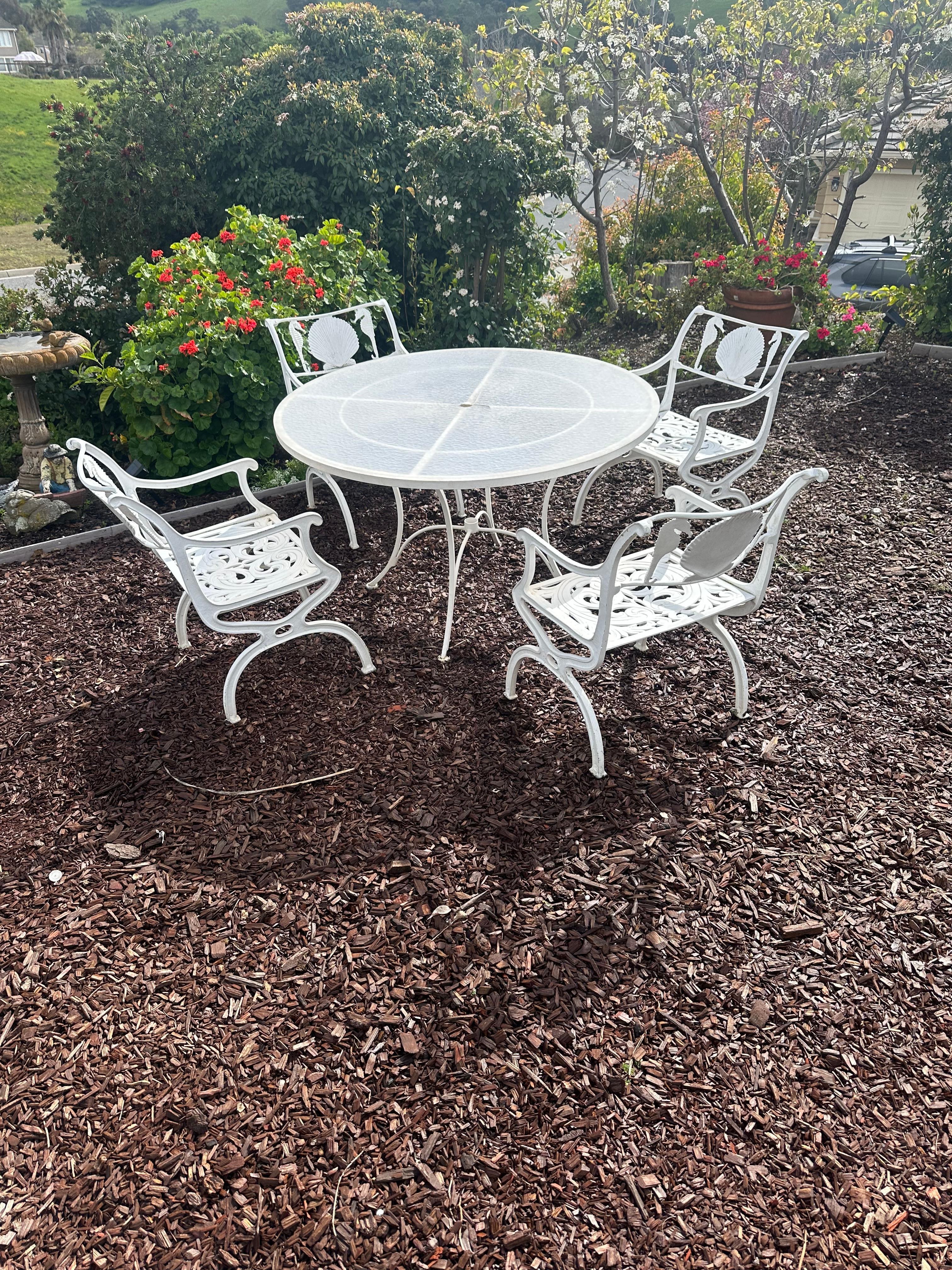 Vintage 1950's Patio Set by Molly of Italy.
5 piece set
Molla's vintage outdoor furniture designs are timeless.
Italian Neoclassical Cast Aluminum chairs with Seahorse and Seashell pattern.
4 Armchairs and round table
**table top is not original and