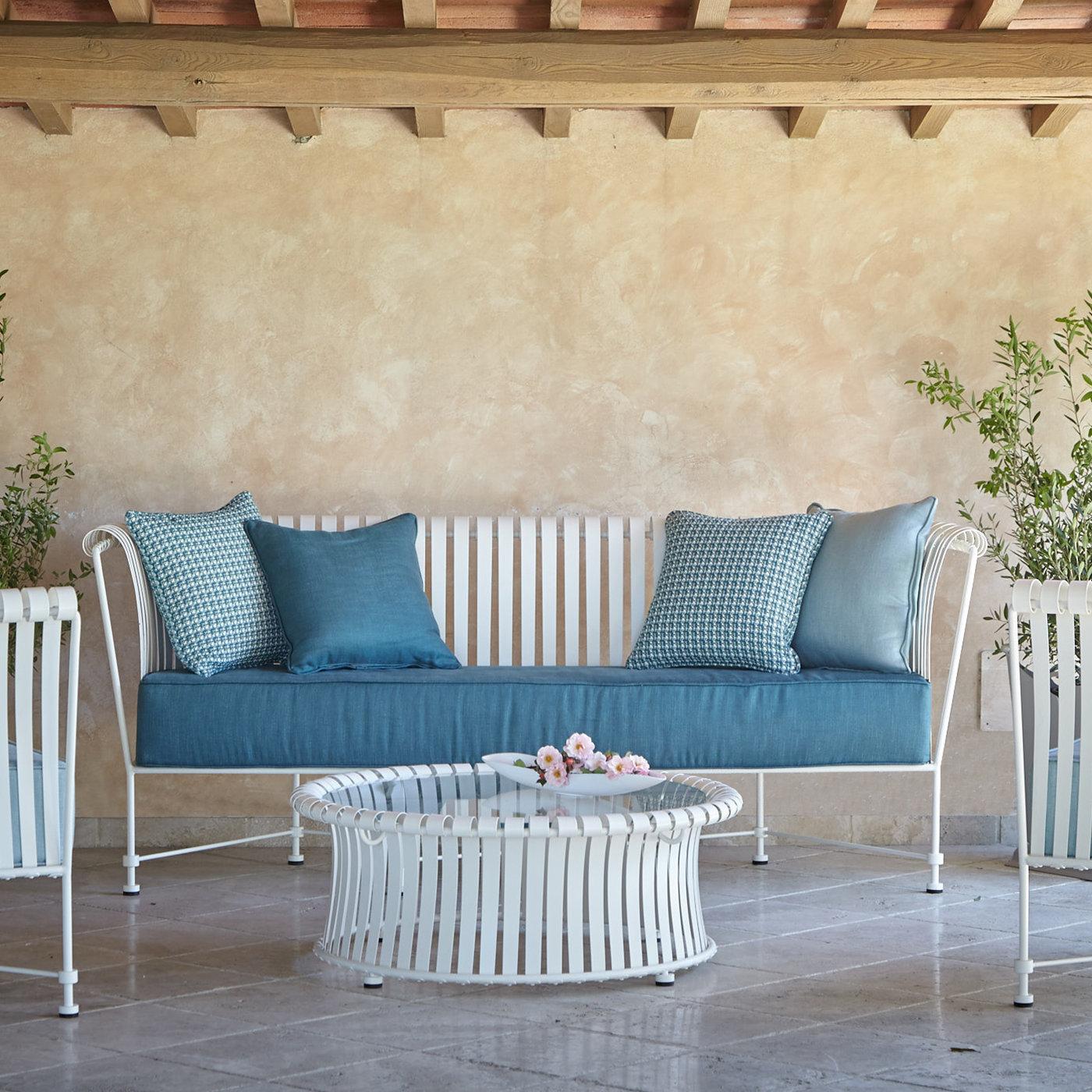 An exquisite addition to the outdoor Molle collection, this coffee table boasts an elegant modern design created in collaboration with Studio63. Fashioned of iron, the base structure features a series of stainless steel strips bent by hand and