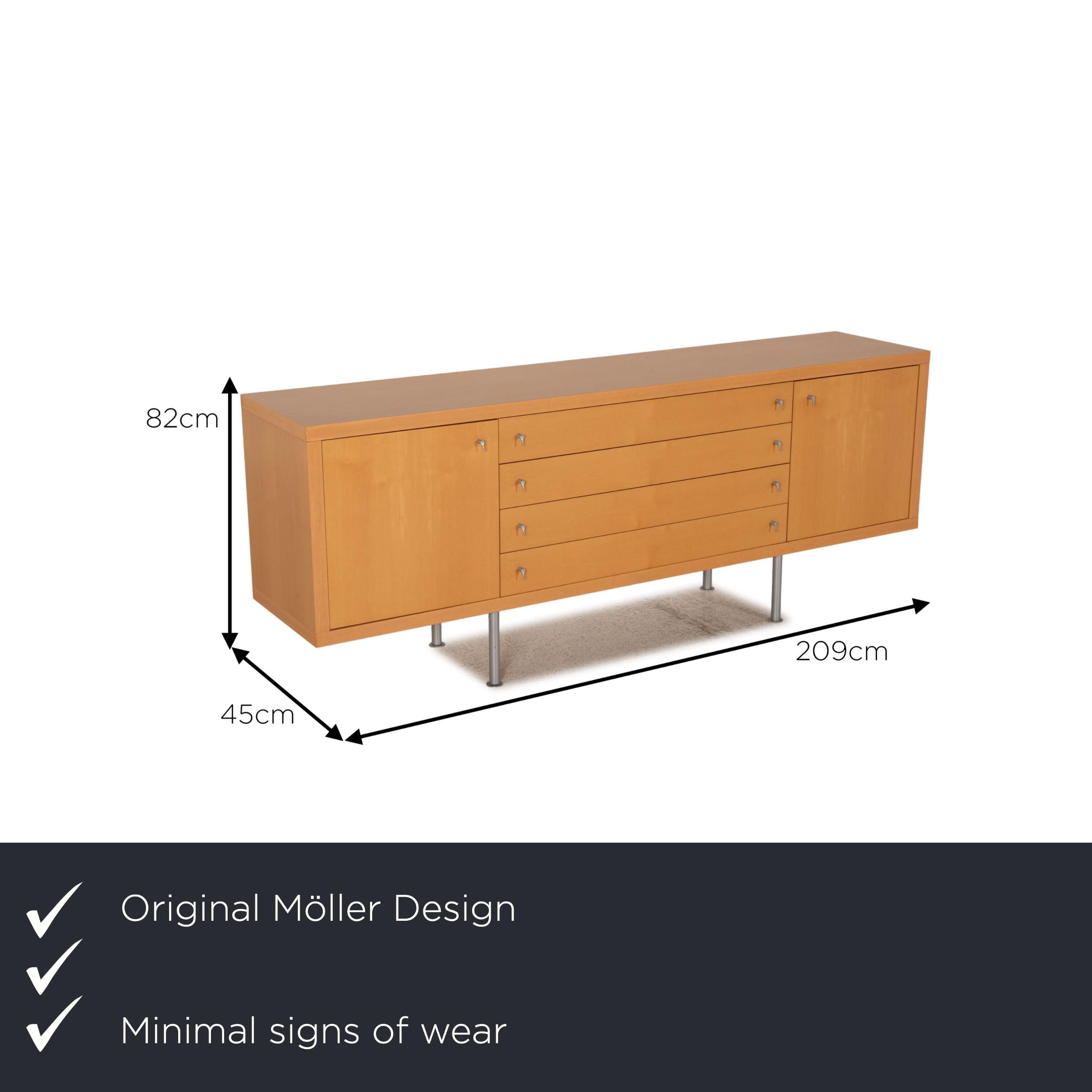 We present to you a Möller Design wood sideboard brown.

Product measurements in centimeters:

depth: 45
width: 209
height: 82
seat height: 
rest height: 
seat depth: 
seat width: 
back height:

 